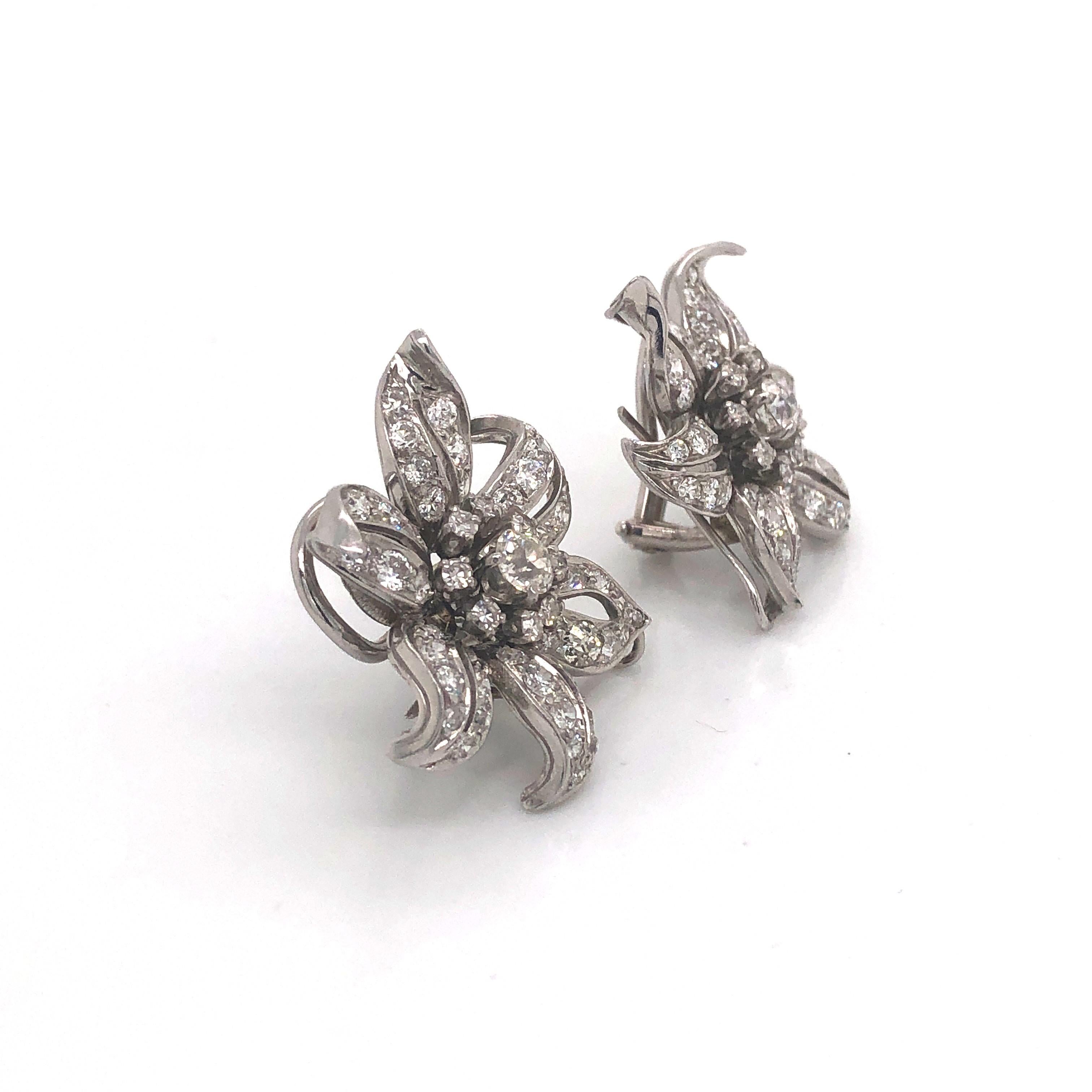 A pair of vintage diamond flower earrings, set with old-cut and eight-cut diamonds, with an estimated total diamond weight of 4.00ct, with clip back fittings, mounted in white gold, circa 1950.