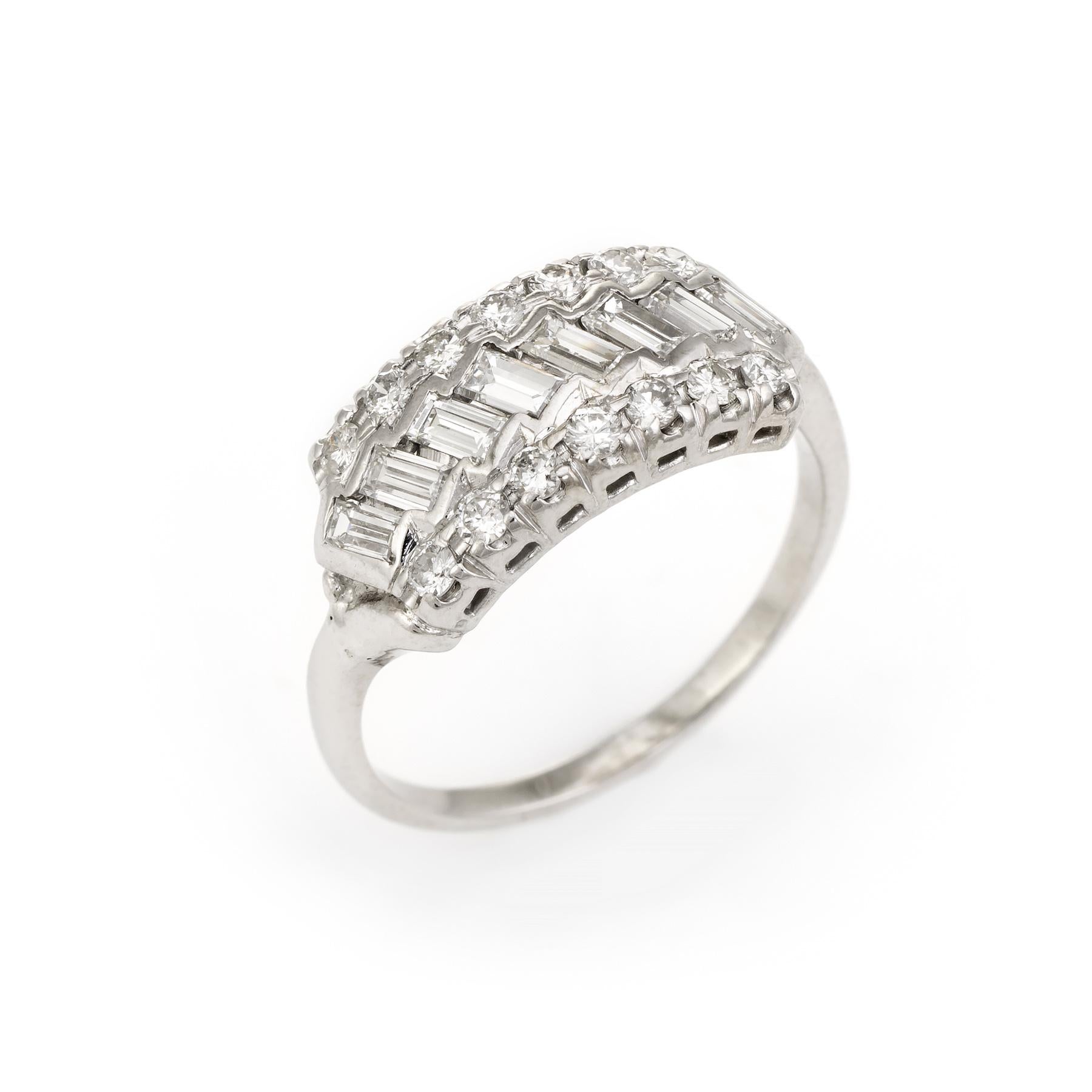 Stylish vintage diamond anniversary ring (circa 1950s to 1960s), crafted in 14 karat white gold. 

Centrally mounted baguette cut diamonds (8) are estimated at estimated 0.07 carats each, accented with 12 estimated 0.03 carat round brilliant cut