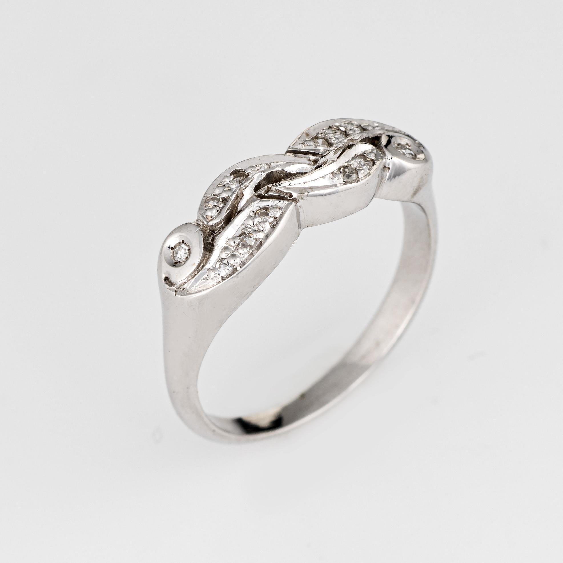 Elegant vintage diamond wedding band (circa 1940s to 1950s) crafted in 14 karat white gold. 

12 diamonds total an estimated 0.06 carats (estimated at I-J color and SI2 clarity).

The ring epitomizes vintage charm and would make a lovely alternative