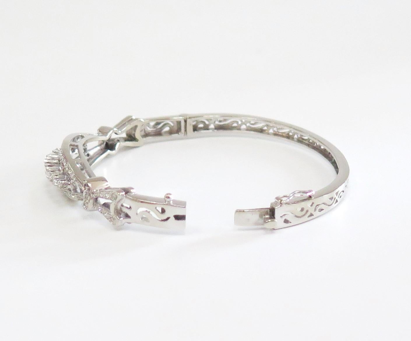 Beautiful 14 Karat White Gold vintage Bangle Bracelet has 1.00 Carat total weight in Diamonds. 
Color: F-H, Clarity: VS/SI.
Weight: 19.6 Grams.

Fits standard 7 inch wrist comfortably.
Lock is tight and has a safety.