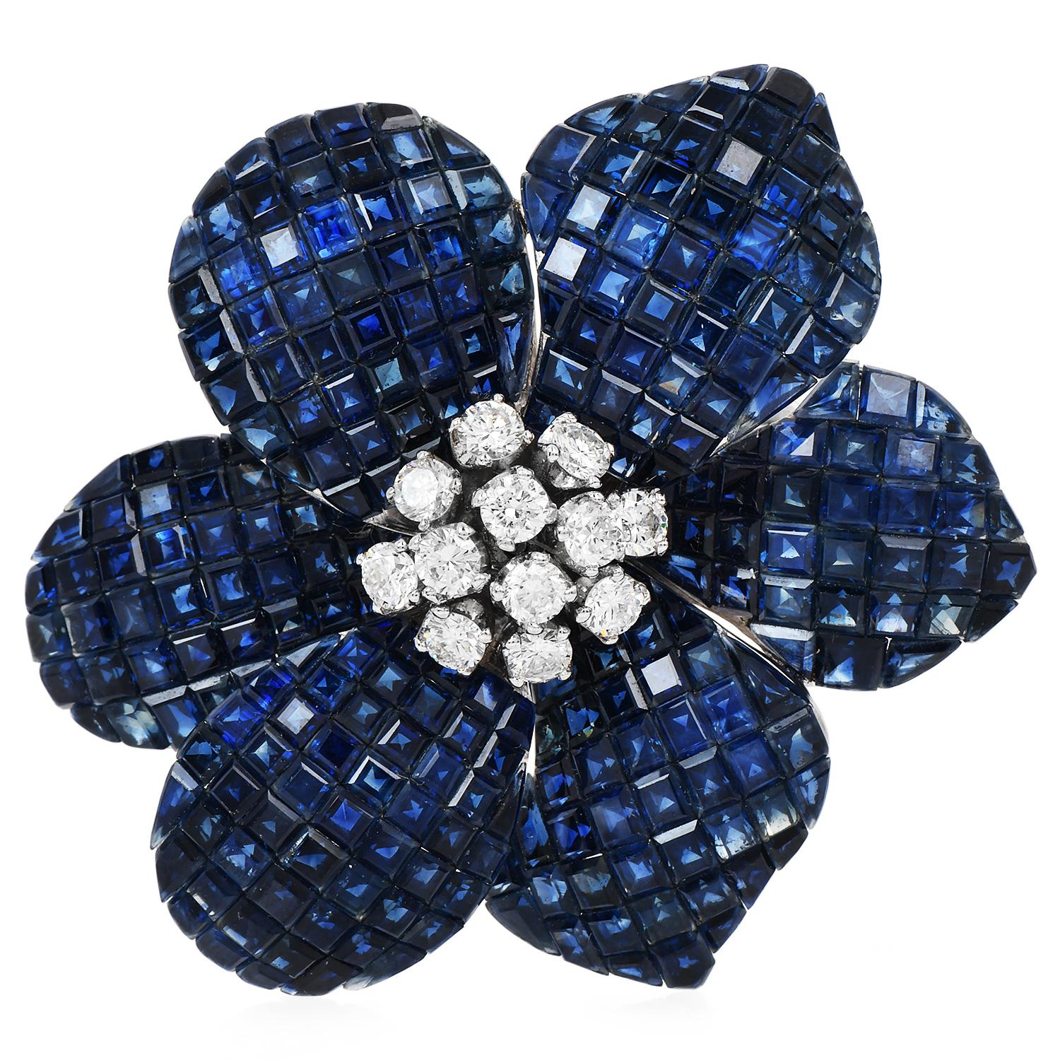 The Vintage Diamond Blue Sapphire 18K White Gold Flower Brooch, is the perfect enhancement for a scarf or blouse.

Crafted in 18K white gold, has a timeless appeal, and a lustrous shine.

The focal point of this piece is the captivating combination
