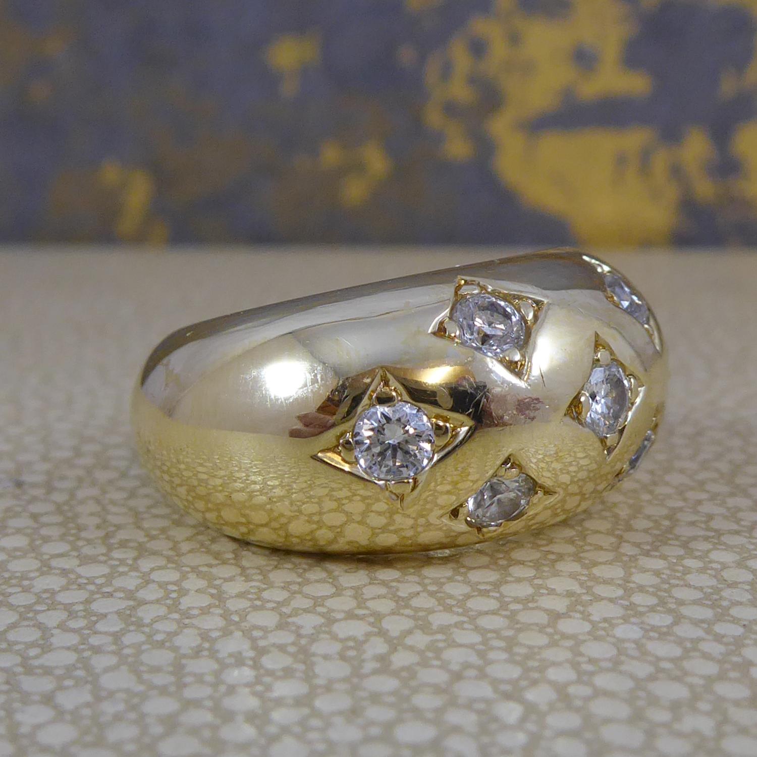 A fabulous bold design ring dating from the late 20th Century.  A polished dome of 18ct yellow gold scatter set with seven brilliant cut diamonds measuring approx. 3.00mm diameter and combiniing to give a total carat weight of 0.75ct.  All claw set