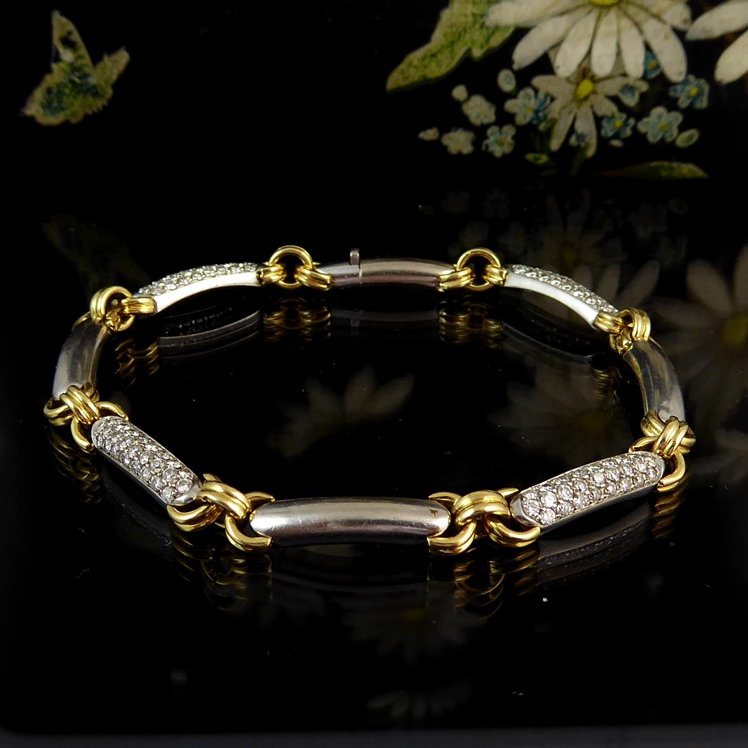 A diamond bracelet blending yellow and white gold in a design that's neither too showy nor too dull.  Comprising sections of slightly curved, dome shaped white gold rectangles approx. 0.63