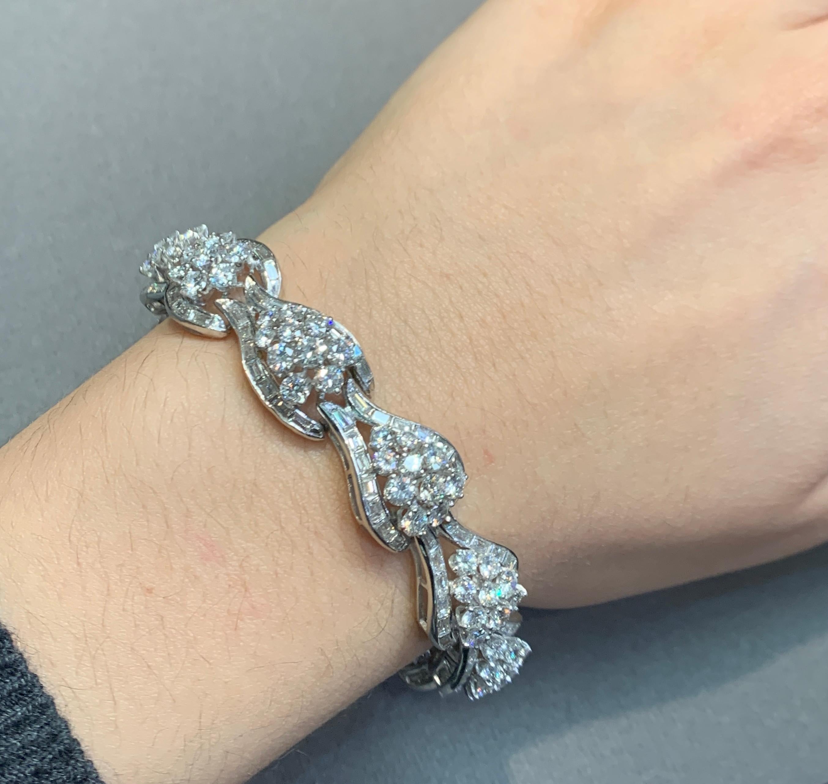 Vintage Diamond Cluster Bracelet

A bracelet consisting of 12 links with round and baguette cut diamonds set in platinum. 

Diamond Weight: approximately 21.4 carats 
Metal Type: Platinum 
Approximately measurements: 7.5