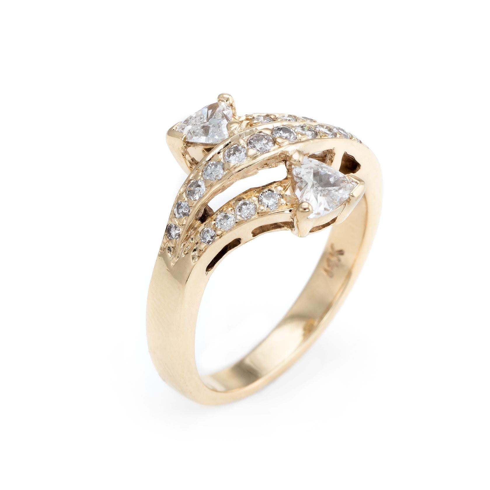 Finely detailed vintage diamond bypass ring, crafted in 14 karat yellow gold. 

Two heart shaped diamonds are estimated at 0.25 carats each, accented with a further 0.38 carats of round brilliant cut diamonds. The total diamond weight is estimated