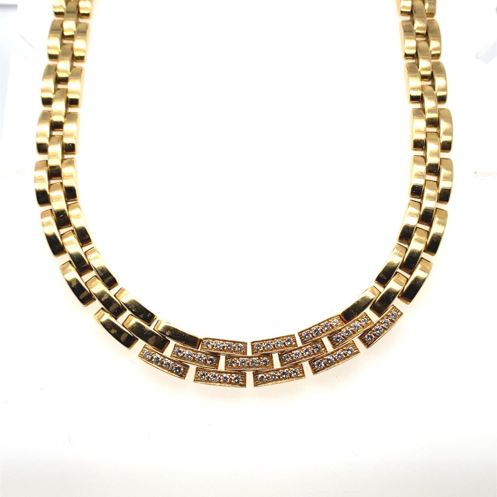 A vintage diamond Cartier Panthère  brick link 18 karat yellow gold collar necklace.

The necklace comprises of a triple row of Cartier's classic flat solid brick style links in 18 karat yellow gold, grain set to its centre with forty eight round