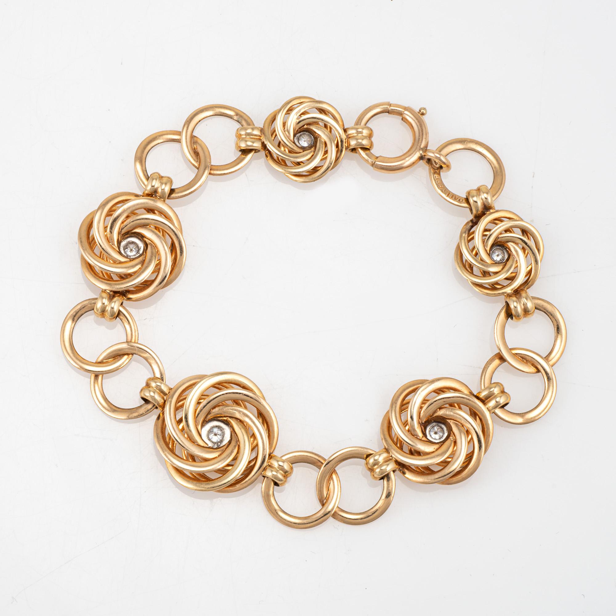 Stylish vintage 'circles' bracelet crafted in 14 karat yellow gold (circa 1950s to 1960s). 

Five diamonds total an estimated 0.20 carats (estimated at H-I color and VS2-SI2 clarity). Graceful in design, diamond set infinity circles are connect to