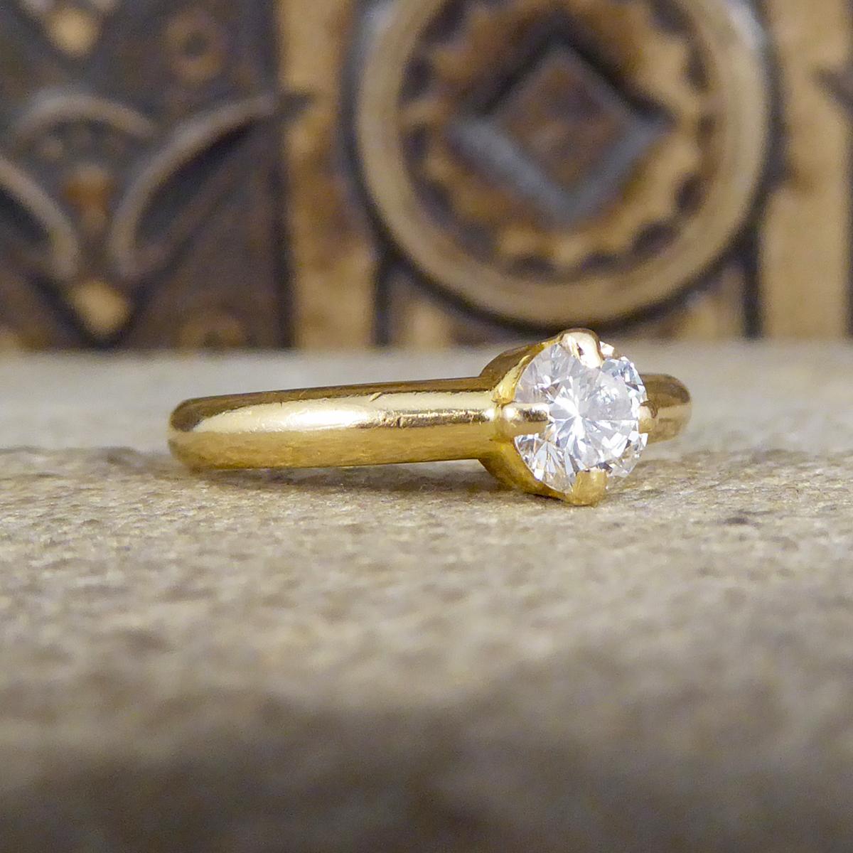 This ring features a round brilliant cut Diamond weighing 0.45ct. It is set in a feature four claw set setting in 18ct Yellow Gold leading down to a 18ct Yellow Gold plain polished band. This beautiful ring would make the perfect classic engagement