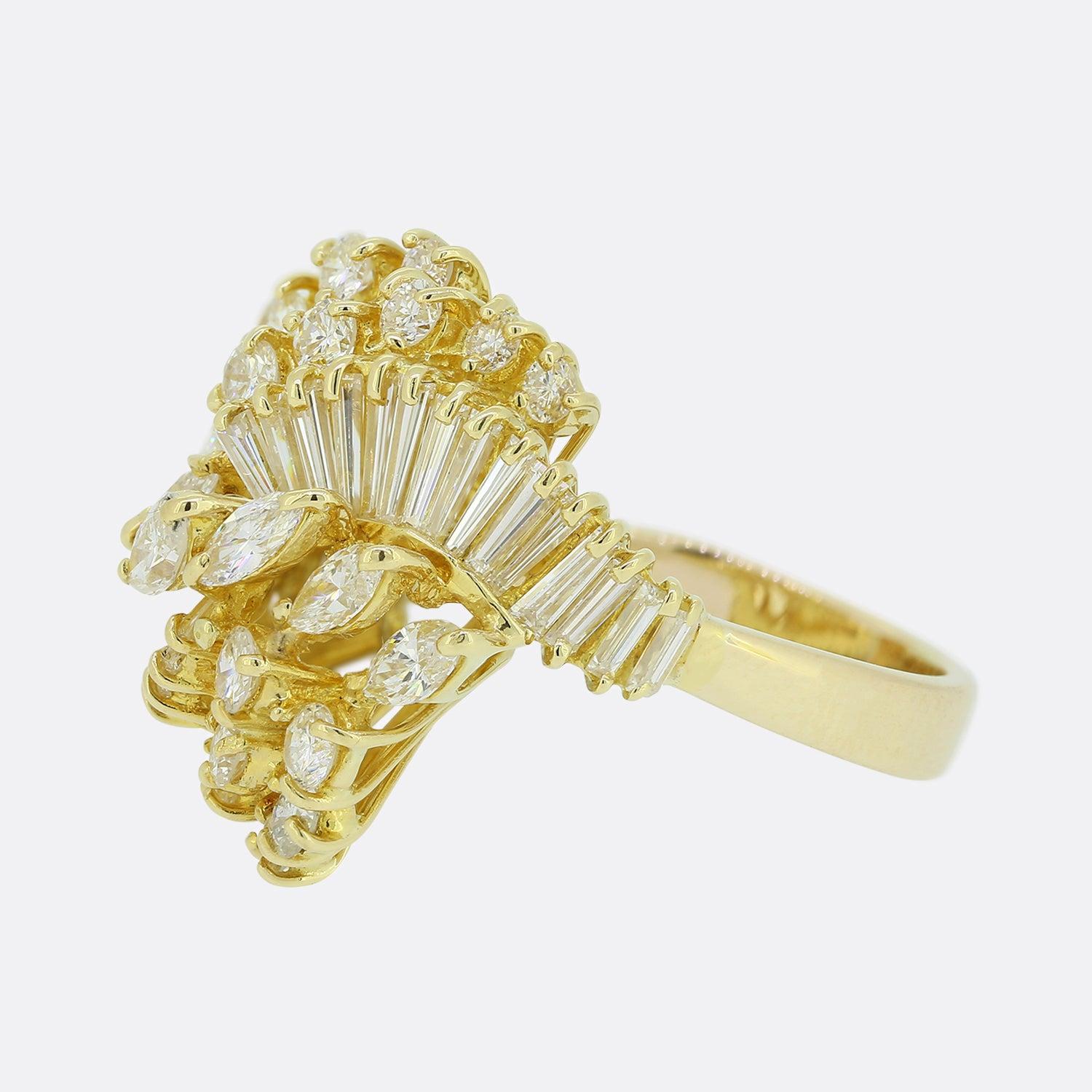 Here we have a gloriously wild vintage diamond dress ring. This piece is formed through five separate clusters of round brilliant, marquise and baguette cut diamonds which sit proud in an undulating fashion. All stones here are wonderfully matched