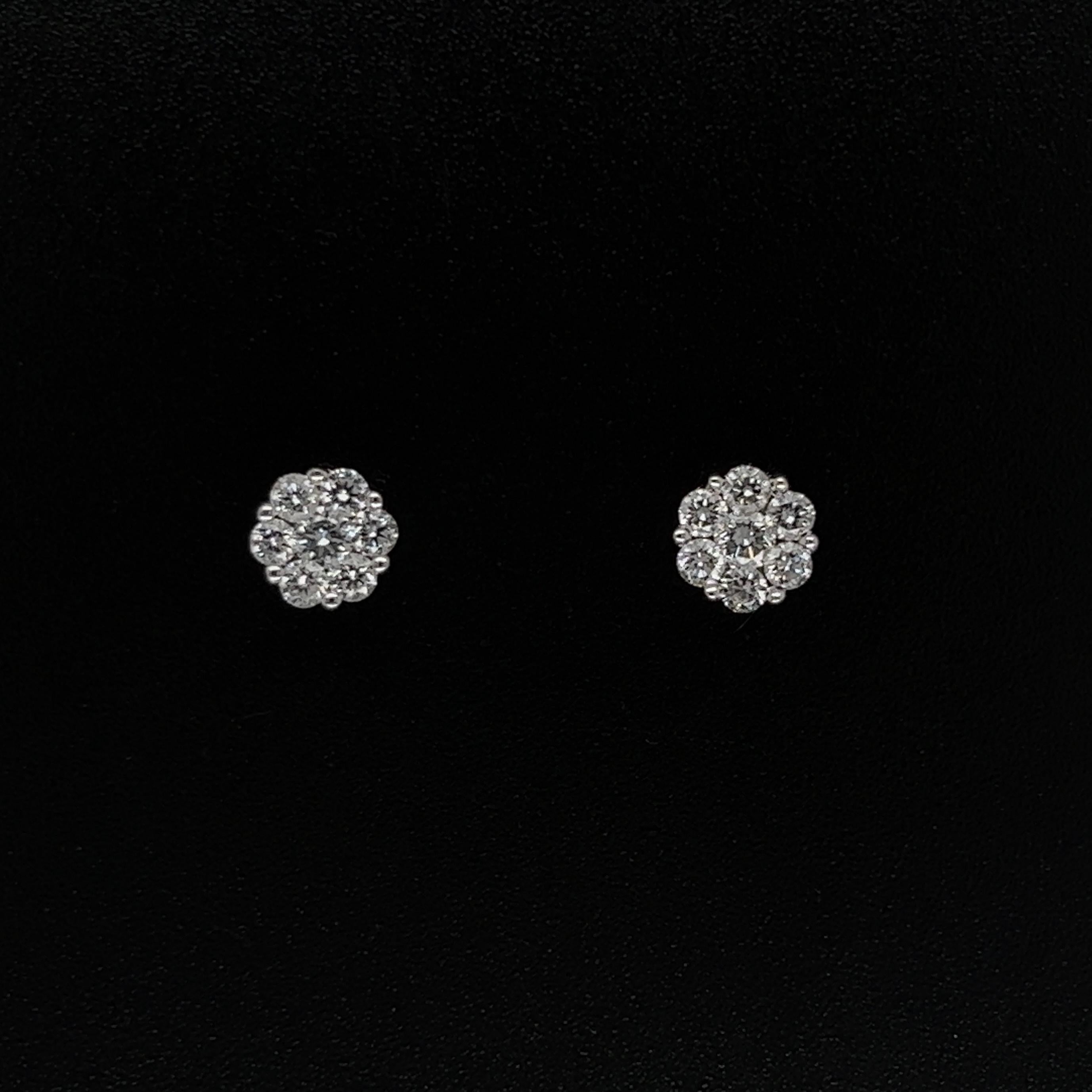 Simply Beautiful! Pair of round Diamond Cluster 5.7mm Gold Stud Earrings. Securely nestled and Hand set in 14 Karat White Gold. Diamonds, weighing approx. 0.45tcw. Measuring approx. 0.50” L x 0.22” W. These earrings are in excellent condition,