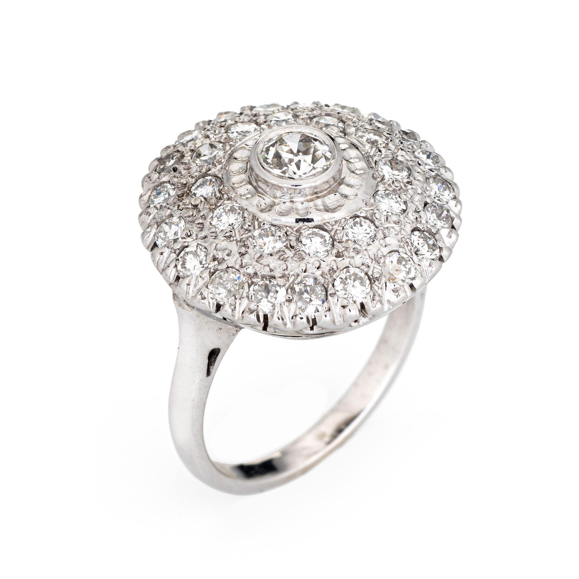 Stylish vintage diamond cluster ring (circa 1950s to 1960s) crafted in 14 karat white gold. 

Centrally mounted estimated 0.20 carat old European cut diamond is accented with an estimated 0.65 carats of diamonds. The total diamond weight is