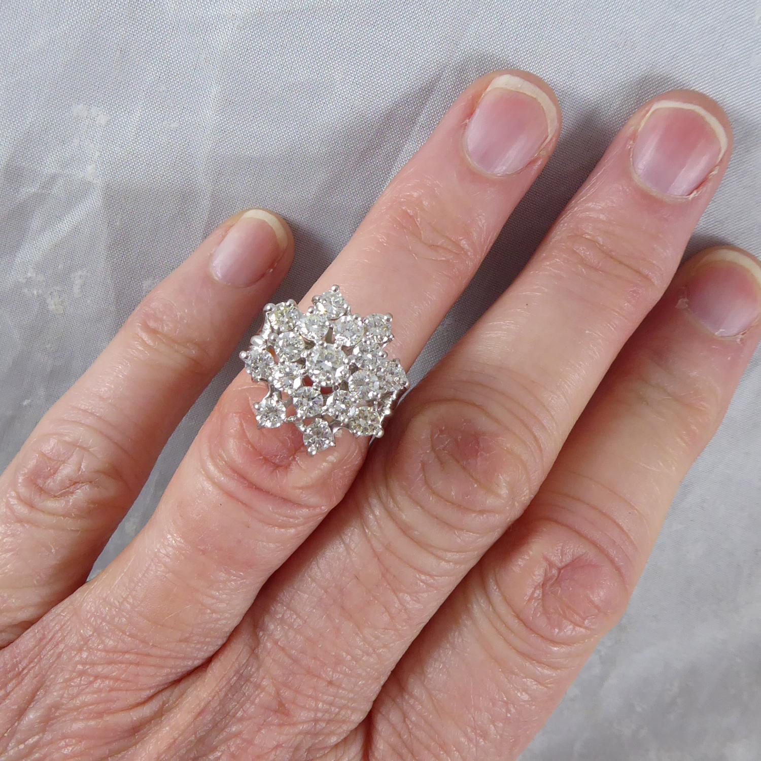 A marvellous diamond cocktail ring.  A central diamond measuring approx. 4.00mm diamond sitting in a cluster surround of 16 further diamonds in a high, white metal head.  

The diamonds total 2.65ct with assessed colour J/K/L and clarity assessed as