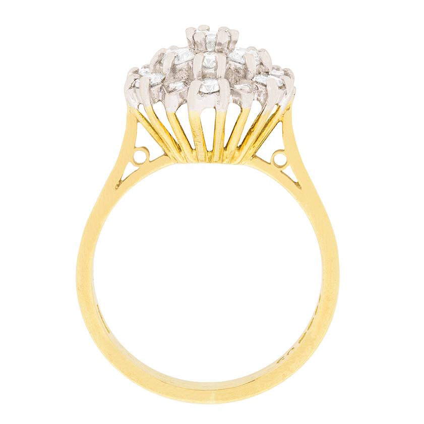 Dating to the 1970s, this classic cluster ring has a total weight of 0.60 carat. The round brilliant diamonds are estimated as G in colour and VS in clarity. They sparkle within their claw settings which are made in 18 carat white gold. The wired