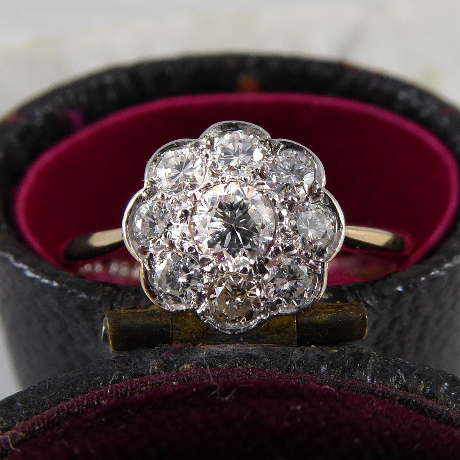 A diamond daisy cluster ring set with nine brilliant cut diamonds, the centre diamond measuring approx. 3.40mm x 3.5mm deep and surrounded by eight further diamonds measuring between 2.00mm and 2.10mm diameter.  Estimated total diamond weight 0.44ct