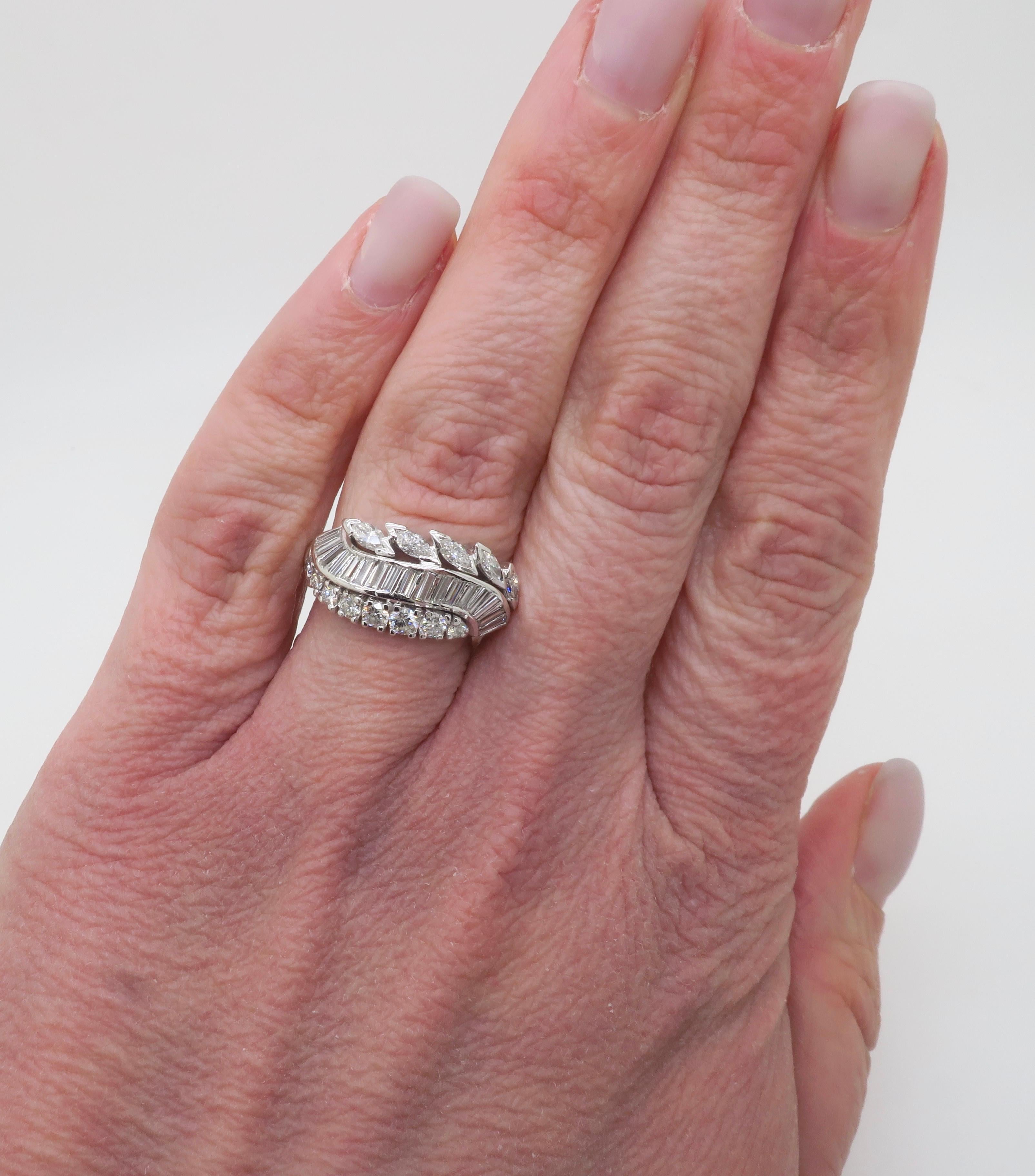 Beautiful vintage Baguette, Marquise, and Round Diamond cocktail ring crafted in white gold. 

Diamond Carat Weight: 1.75ctw
Diamond Cut: Round Brilliant, Baguette, Marquise 
Color: E-G
Clarity: VS1-SI1
Metal: 14k White Gold 
Stamped: 