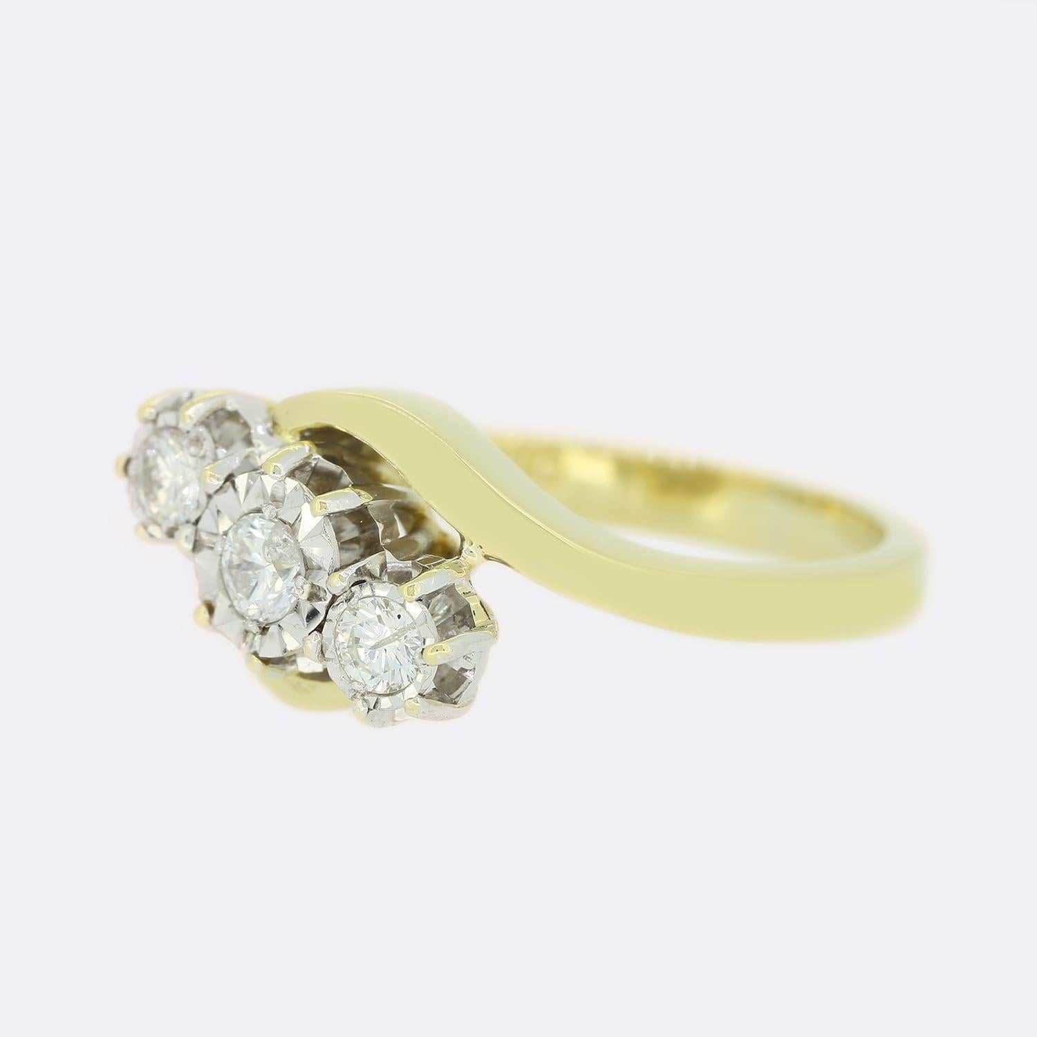 This is an 18ct yellow gold diamond crossover ring. The 3 diamonds are illusion set in white gold to make them appear slightly larger.

Condition: Used (Very Good)
Weight: 4.9 grams
Size: L 1/2
Total Diamond Carat Weight: 0.25 carats
Diamond