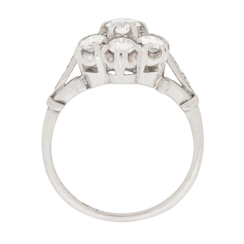 This show stopper cluster ring is in a typically vintage daisy look. It features a centre stone weighing 0.35 carat and is haloed beautifully by 6 round brilliant diamonds each weighing 0.30 carat. This brings the total to 2.15 carat, and the stones