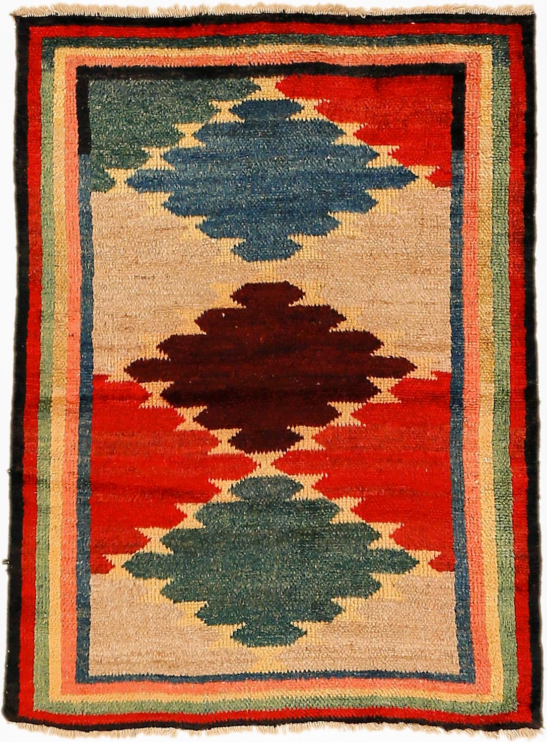 A lovely Kurdish Tulu rug distinguiished by a honeycomb arrangement of colourful diamonds. A perfect accent rug that can work with both modern as well as antique furniture.