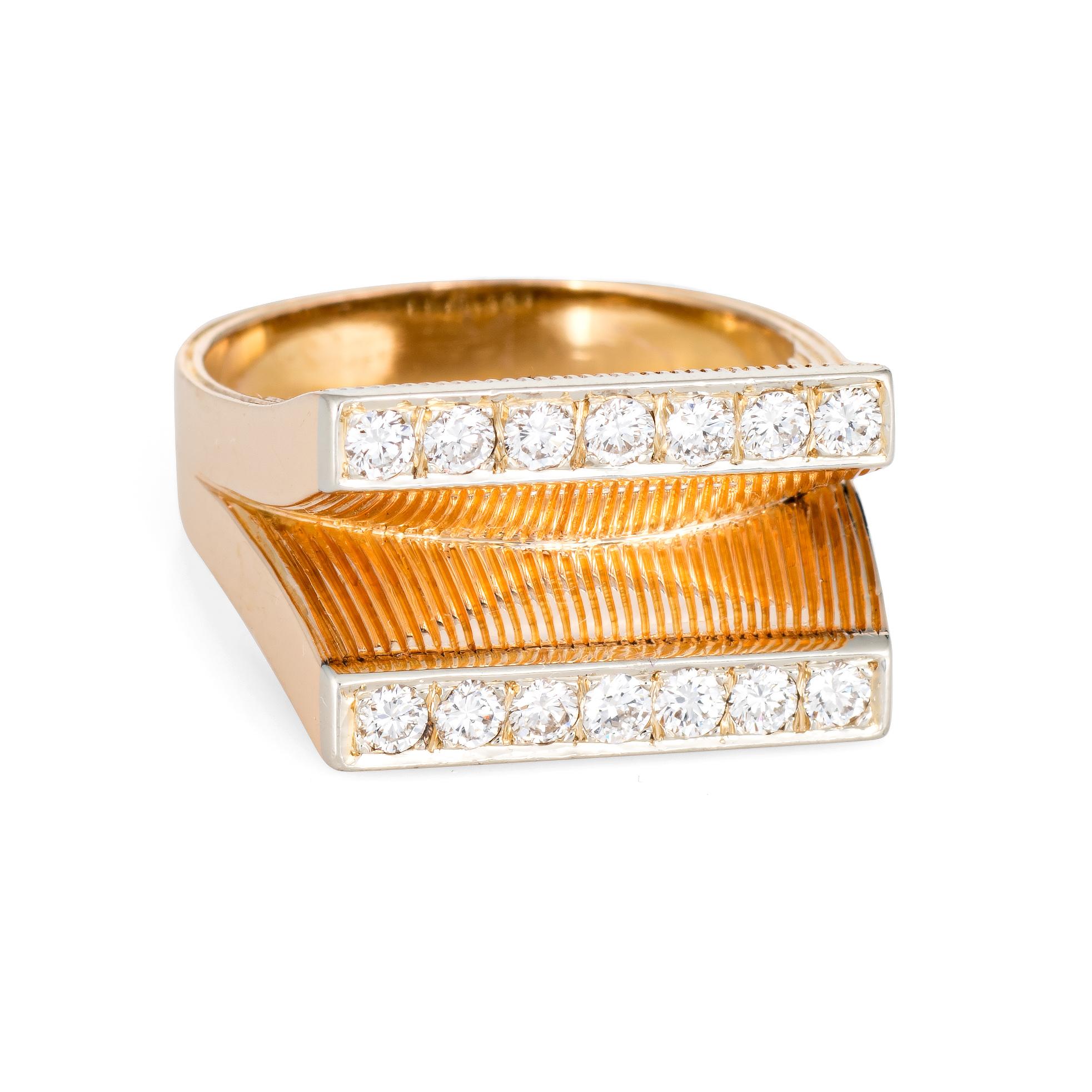 Finely detailed vintage diamond double bar ring (circa 1980s) crafted in 14 karat yellow gold. 

14 round brilliant cut diamonds are estimated at 0.04 carats each and total an estimated 0.56 carats (estimated at G-H color and VS2-SI1 clarity). 

The