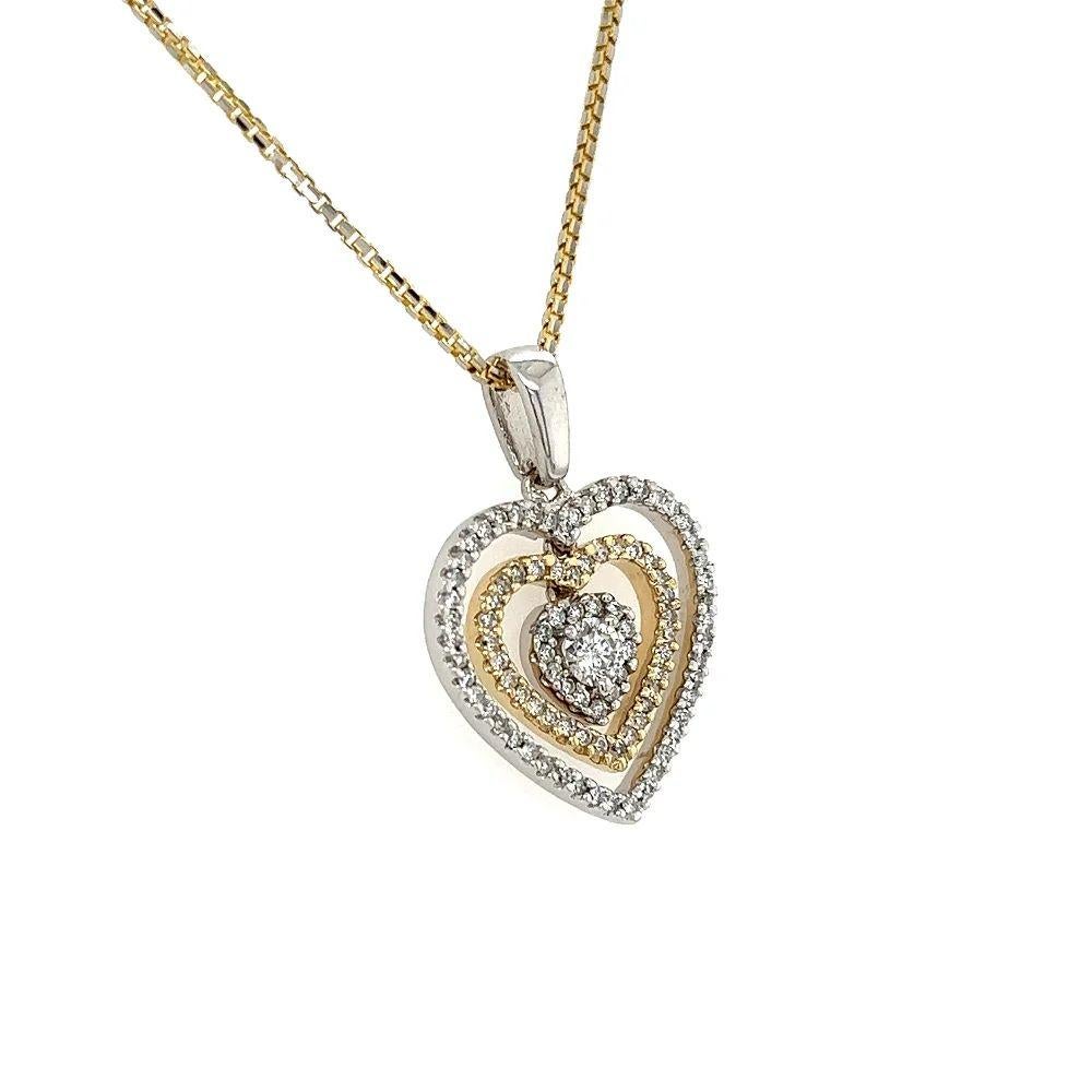Simply Beautiful! Vintage Double Heart 2-Tone Gold Diamond Pendant Necklace. Centering a Hand set 0.22 Carat RBC Diamond and surrounded by Diamonds, weighing approx. 0.47tcw. Hand crafted 2-tone 14K Gold mounting. Suspended from a Gold chain,