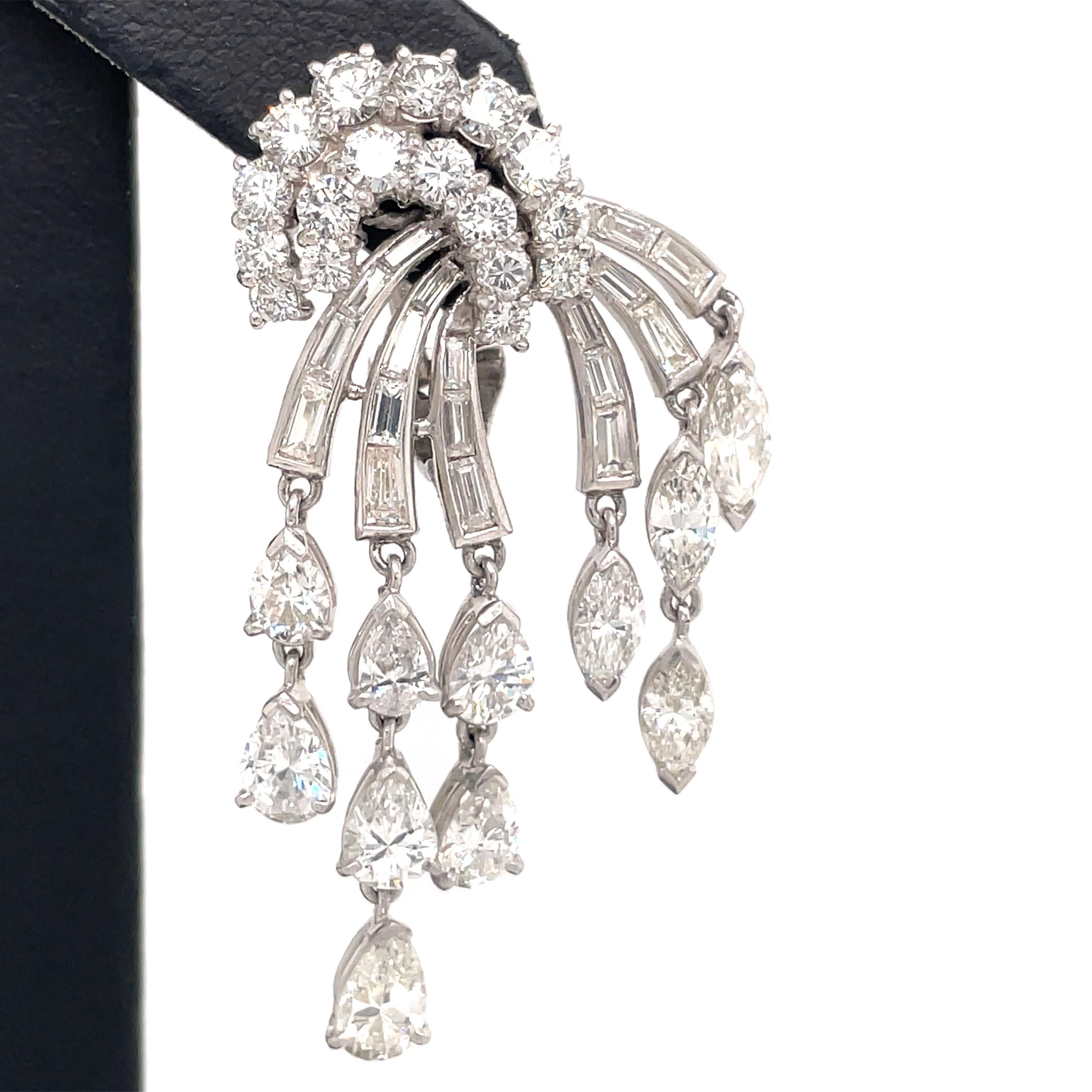 Vintage diamond drop tassel earrings featuring a cluster of round, baguette, marquise and pear shape diamonds weighing approximately 12.50 carats, crafted in platinum. 
Color G-H
Clarity SI
