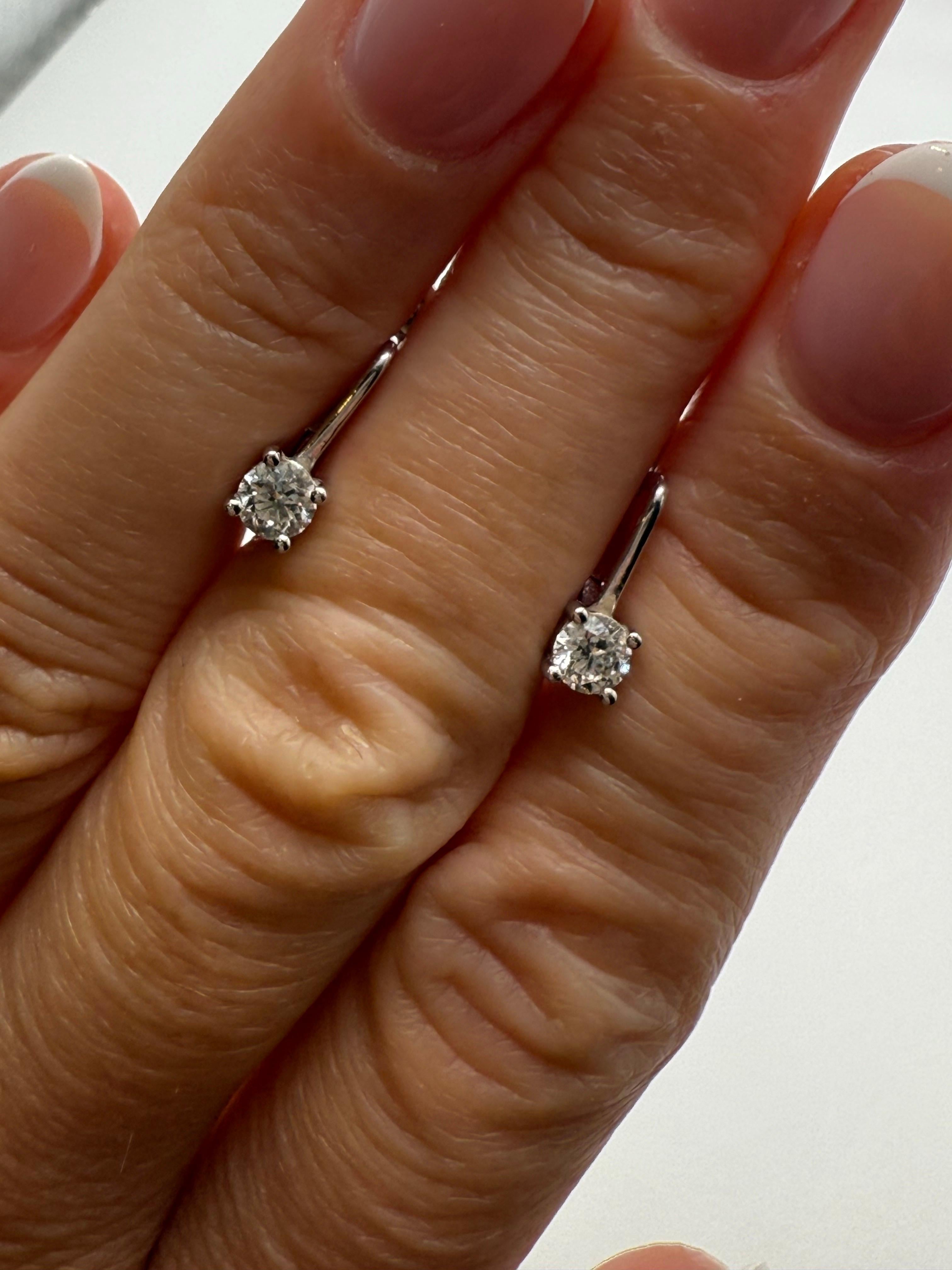 English lock earrings or lever back earrings with a hinge, nice weight to them, small space to have that right under the ear diamond style, very unique made in 14KT white gold, total diamond weight 0.60 carats SI clarity, F-G color.

**All items