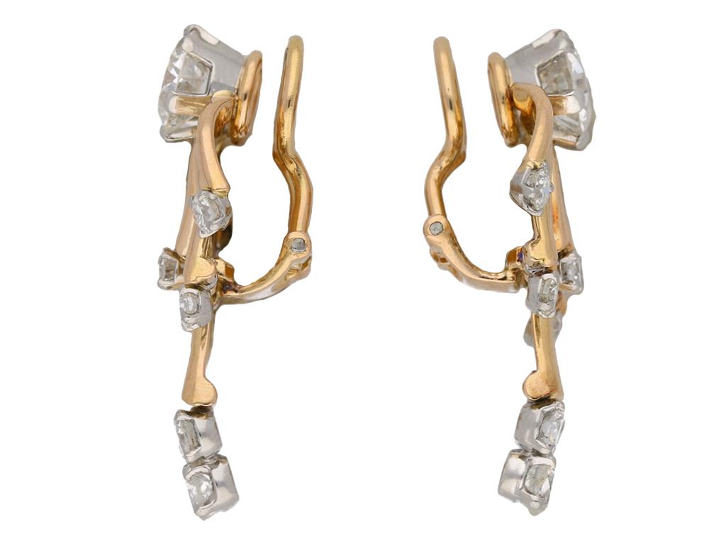 Vintage diamond earrings. A marching pair, each set with a round old cut diamond, the first H colour, VS1 clarity with an approximate weight of 1.12 carats in an open back claw setting, the second G colour, VS1 clarity with a weight of 1.05 carats,