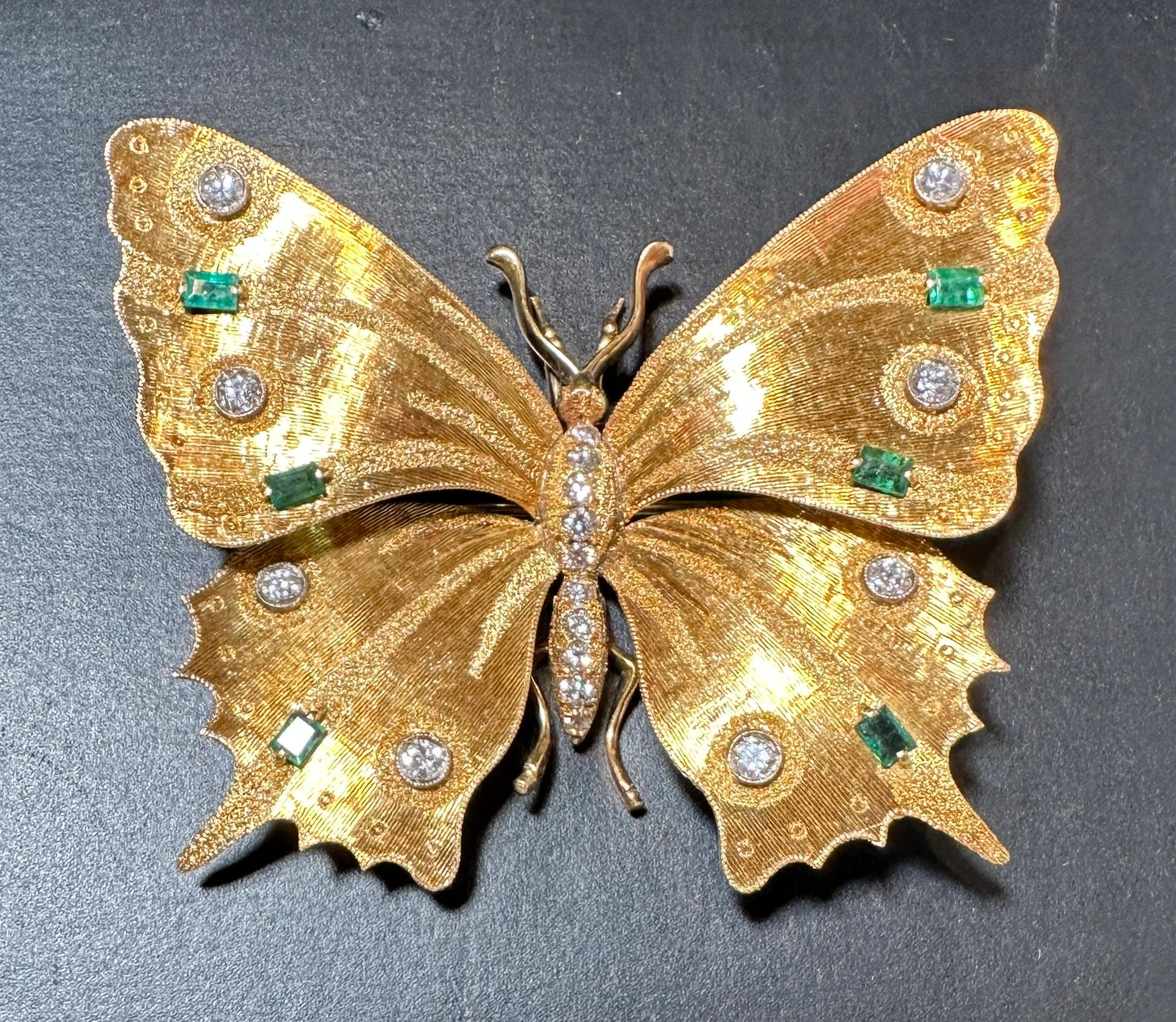Gold, 18 karat diamond and emerald brooch pin in the form of a butterfly. 18 round diamonds  approximately .60carats G color SI1 clarity. 6 baguette emeralds. 
20.2g 
60mm x 51mm. 
Marked 750.