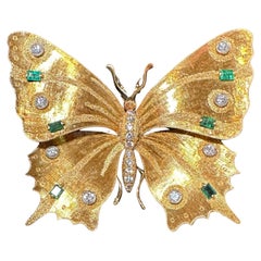 Broche papillon vintage en or 18 carats, diamants et émeraudes