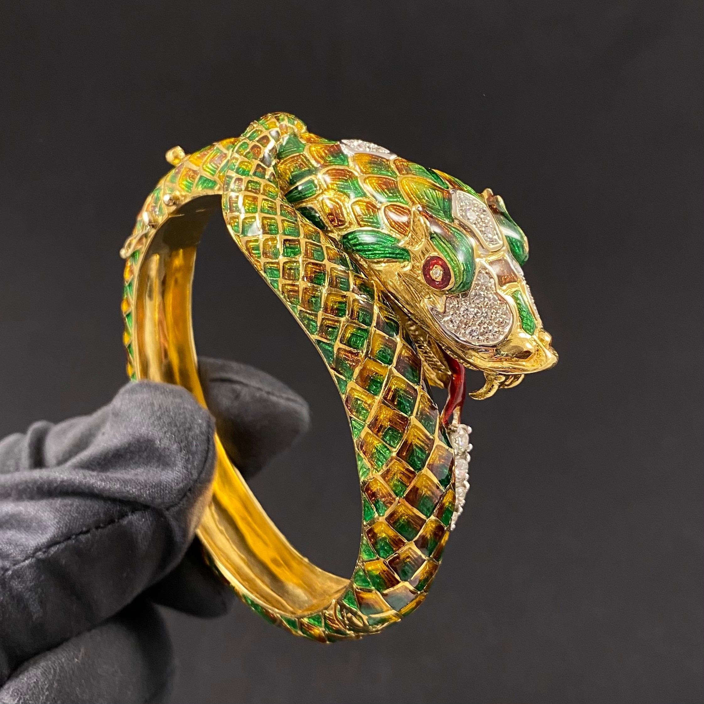 Vintage Diamond and Enamel Serpent Hinged Bangle Bracelet in 19.2kt Yellow Gold, Portugal, circa 1970. Designed as a coiled snake with the mouth open, depicted as if eating a row of four round brilliant-cut diamonds. The snake is decorated