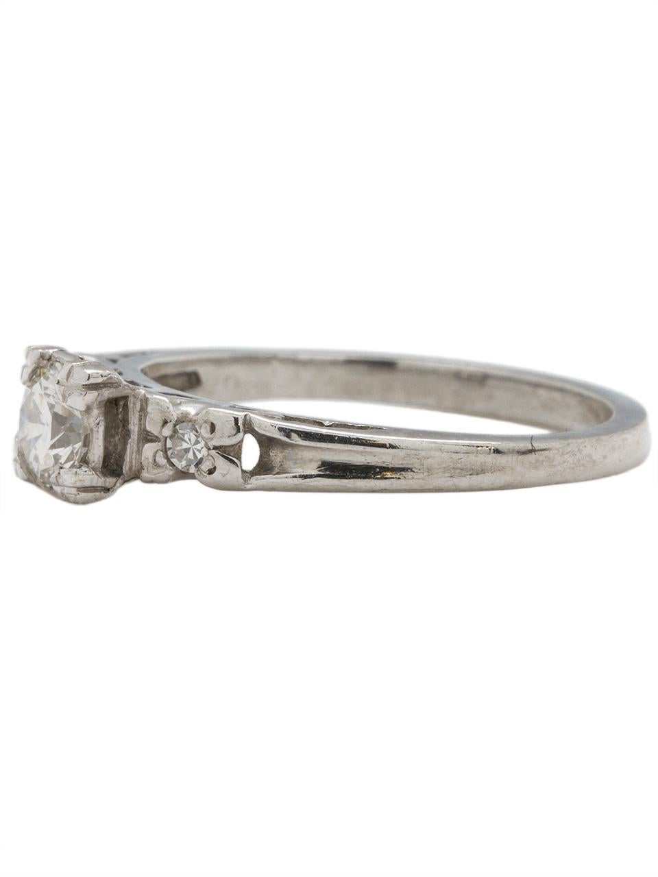 Lovely vintage platinum diamond engagement ring featuring a 0.45ct I-VS1 round brilliant cut flanked by two small single cut side stones. Gorgeous Retro design and open galleries with raised setting. Lovely paired with a vintage diamond wedding