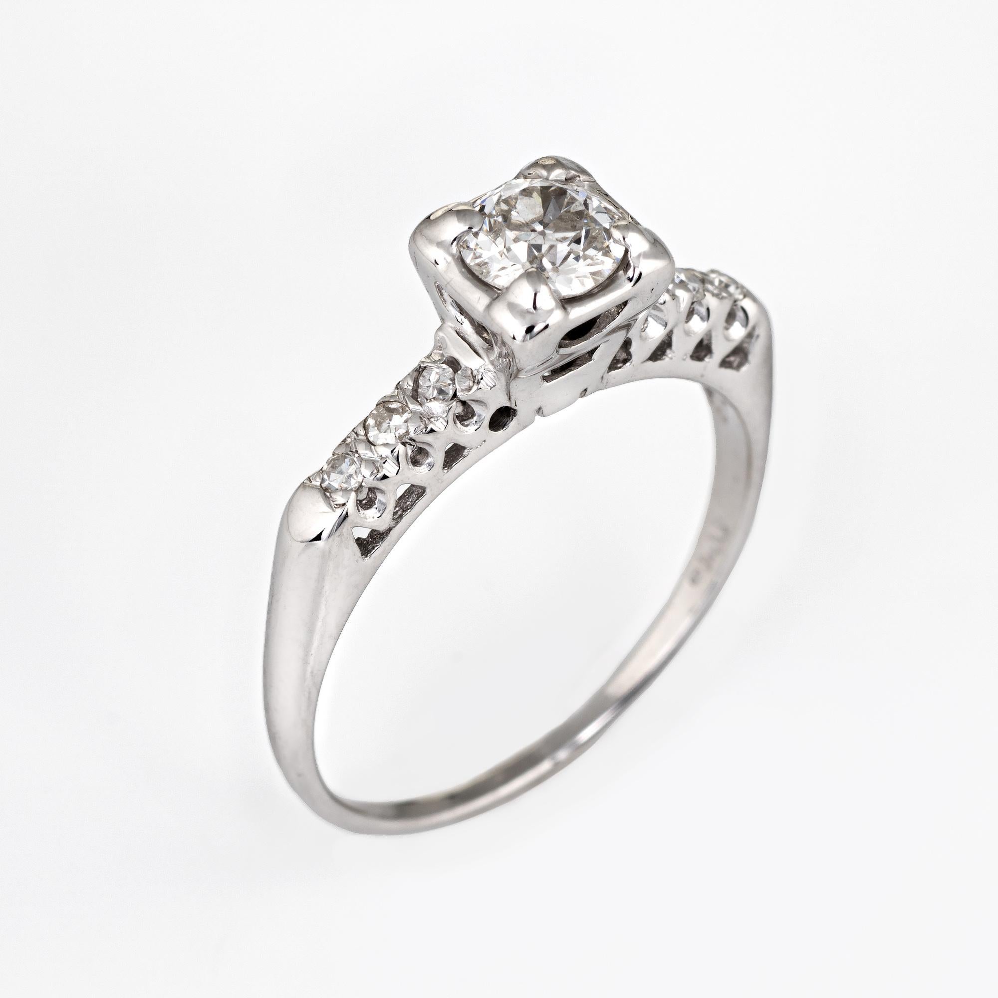 Finely detailed vintage diamond engagement ring (circa 1950s to 1960s) crafted in 14 karat white gold.

Centrally mounted old European cut diamond is estimated at 0.50 carat, accented with six estimated 0.01 carat single cut diamonds. The total