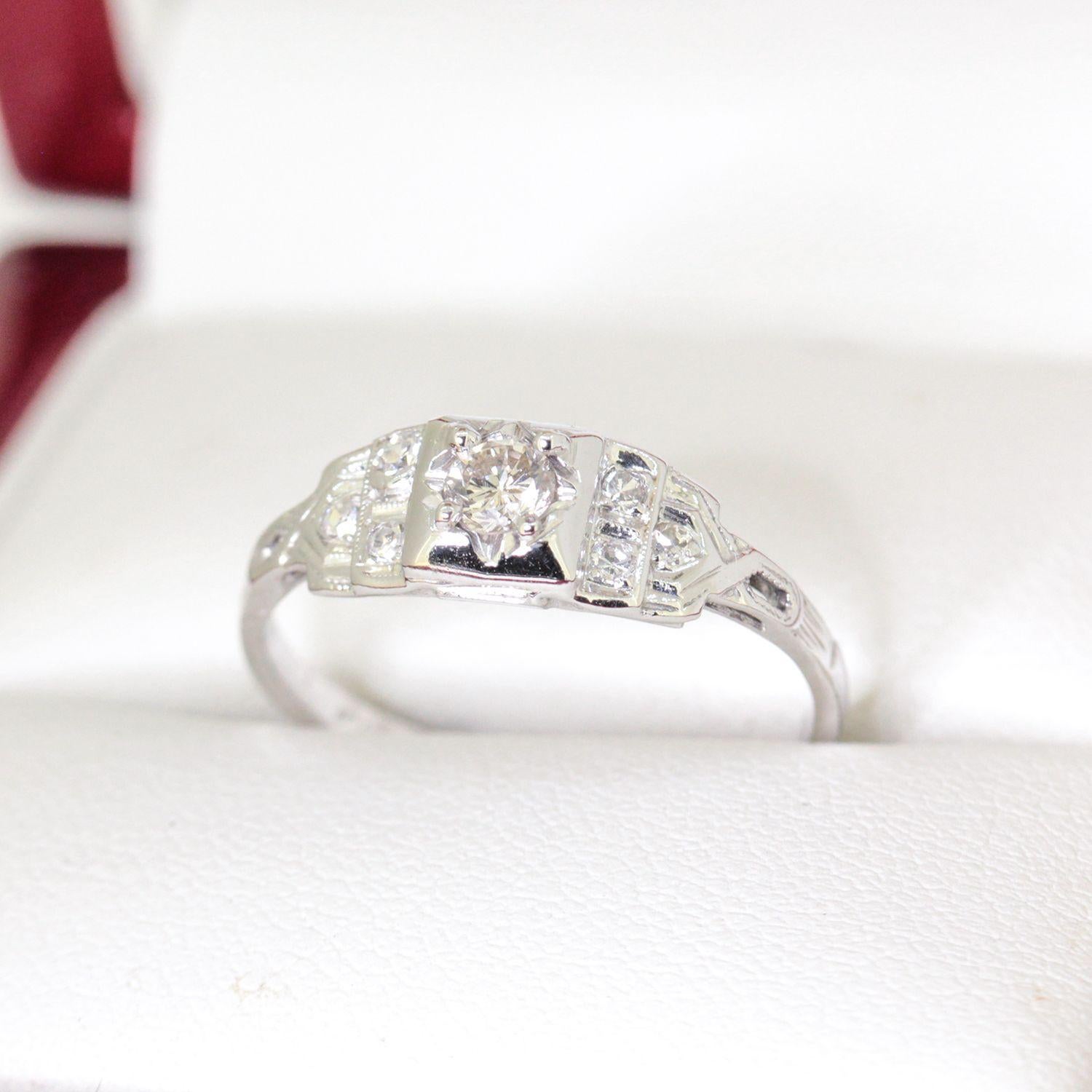 Vintage Filigree 18ct White Gold Diamond Engagement Ring with 4 claws low round diamond tapered shank.

One ladies 18ct white gold engagement ring, narrow, low half round, tapered shank, 4 claw setting, polished finish, acid tested, unstamped.

The