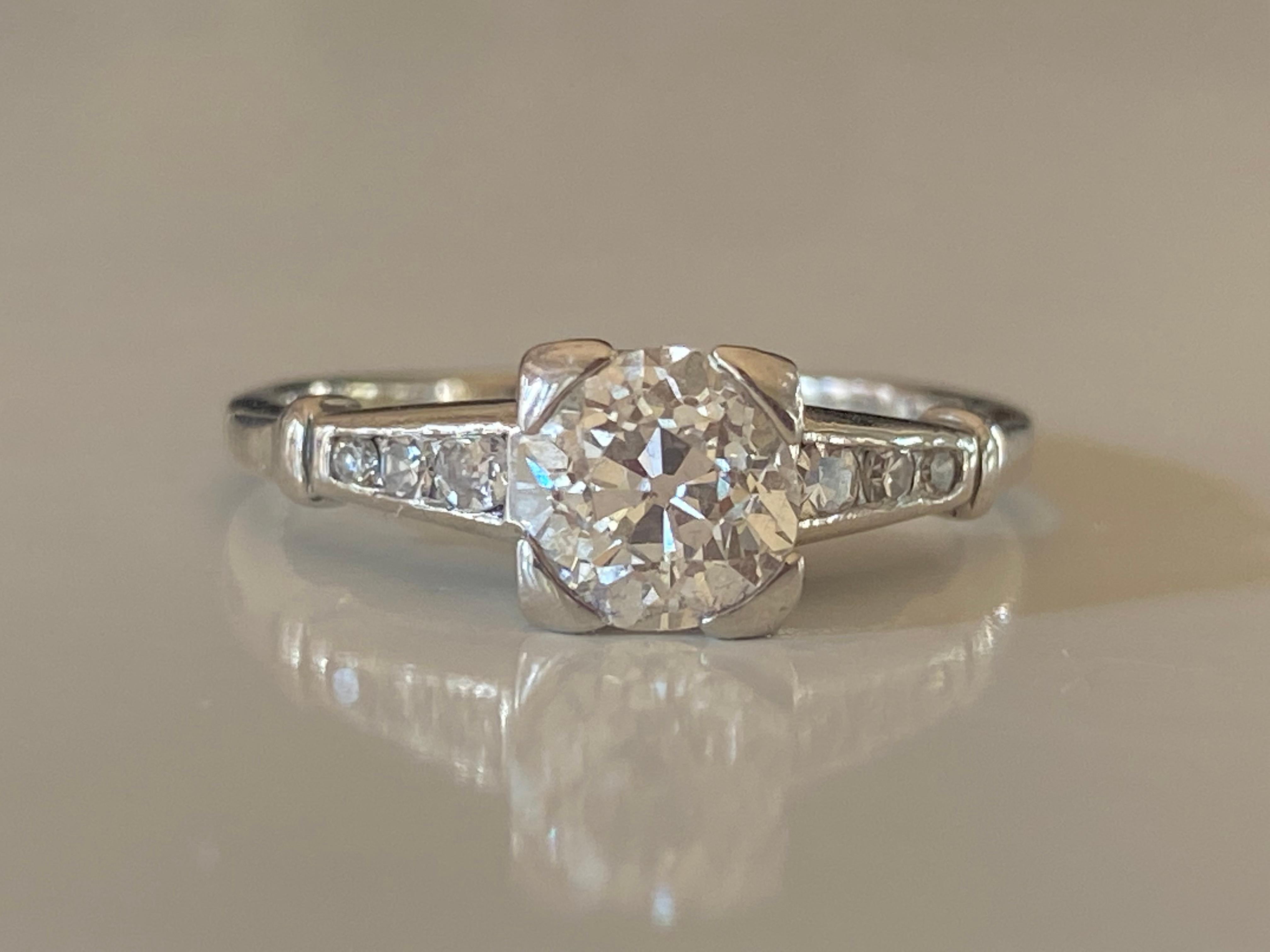 This stunning band is meticulously crafted in platinum and set with a striking Old European cut center stone totaling 1.01 carat, G-H color, SI1 clarity and  flanked by six single cut diamonds totaling 0.12 carats, F color, SI1 clarity. Circa 1940s.