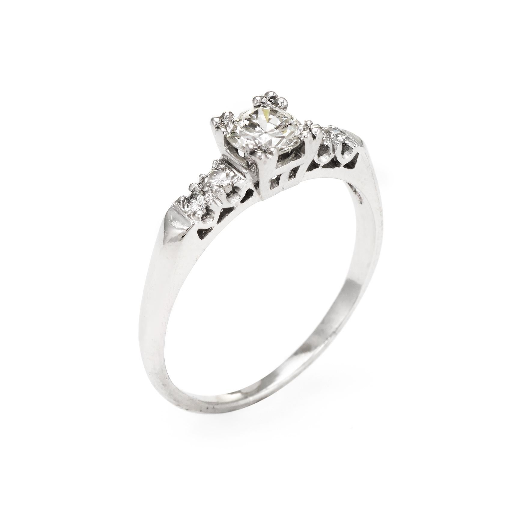 Elegant & finely detailed vintage engagement ring (circa 1950s to 1960s), crafted in 900 platinum. 

Centrally mounted estimated 0.50 carat Old European cut diamond is accented with four estimated 0.02 carat single cut diamonds. The total diamond