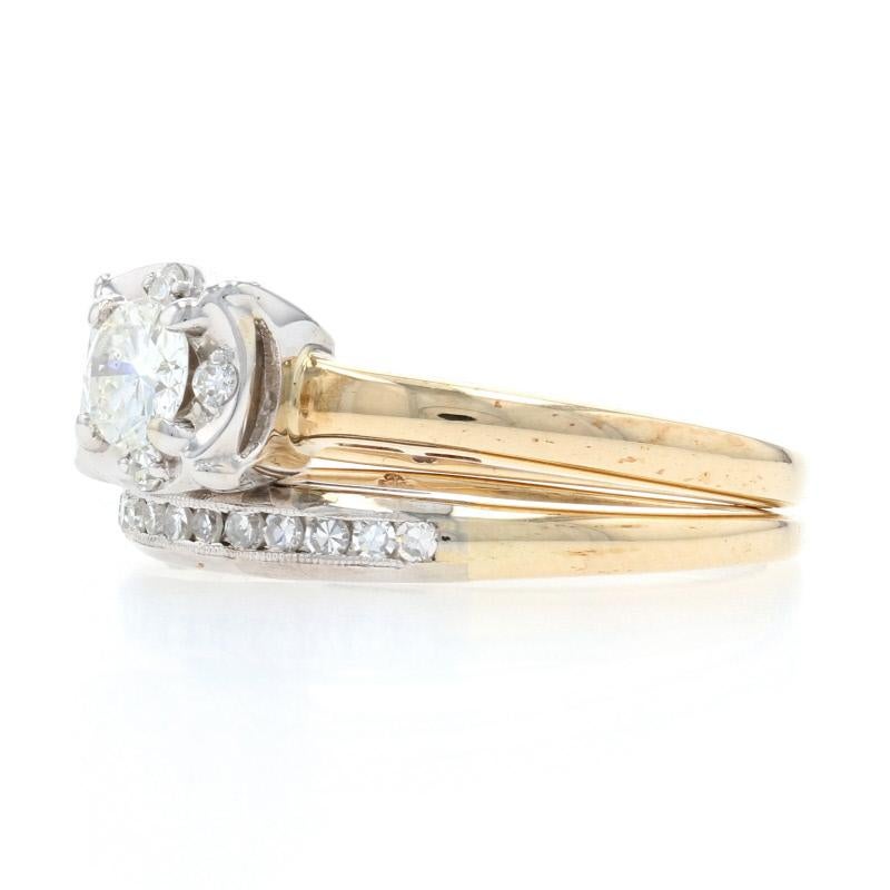 Celebrate your timeless love story with this resplendent vintage bridal set! Crafted in 14k yellow and white gold, this set consists of an engagement ring and matching milgrain-adorned wedding band which are both adorned with sparkling white
