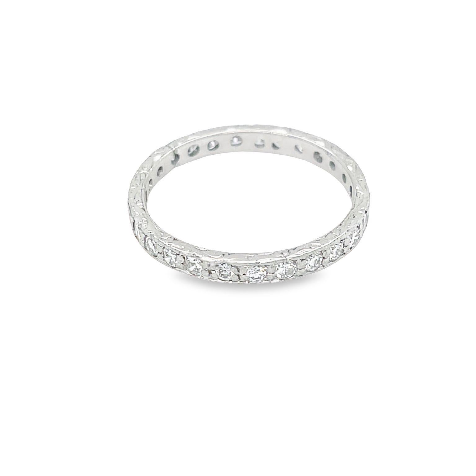 This is a beautiful and classic art deco design band made of handcrafted platinum. It features 27 round cut diamonds with a total weight of 1.35 carat. The diamonds are graded F-G color and VS-SI clarity. The band is adorned with intricate hand