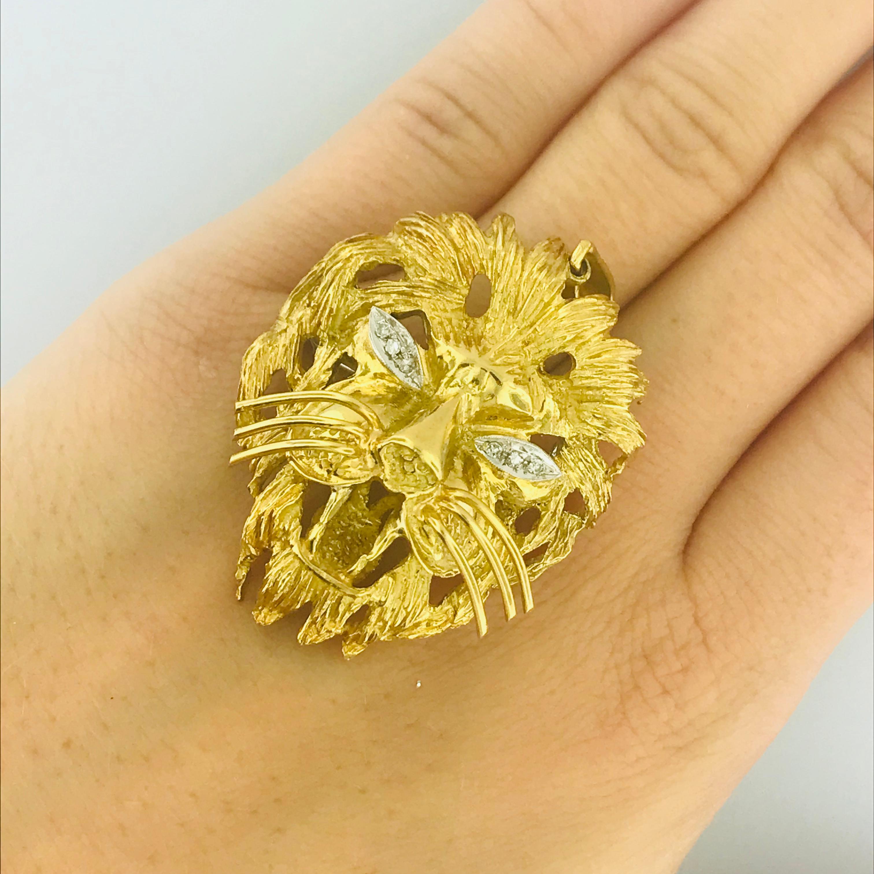 This 18k yellow gold diamond-eye'd lion pin/pendant is marvelous! The coolest feature (besides the diamond eyes) is the ability to turn this brooch/pin into a pendant and vice versa. This lion has a hand-crafted texture resembling fine lion hair