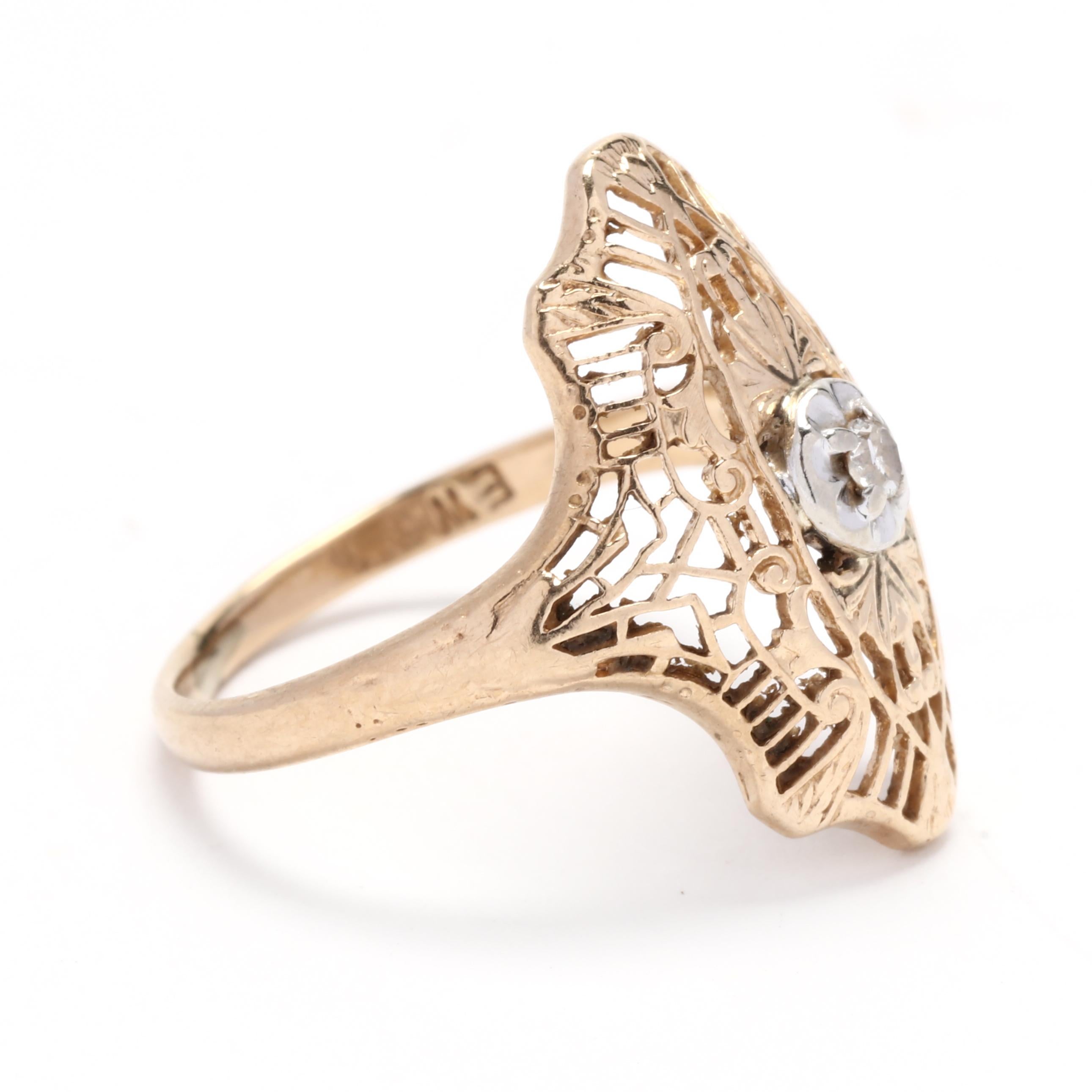 This vintage diamond filigree ring is a stunning piece crafted from 10k yellow and white gold. The intricate filigree design adds a touch of elegance and vintage charm to the ring, making it a timeless and unique piece of jewelry. The center of the