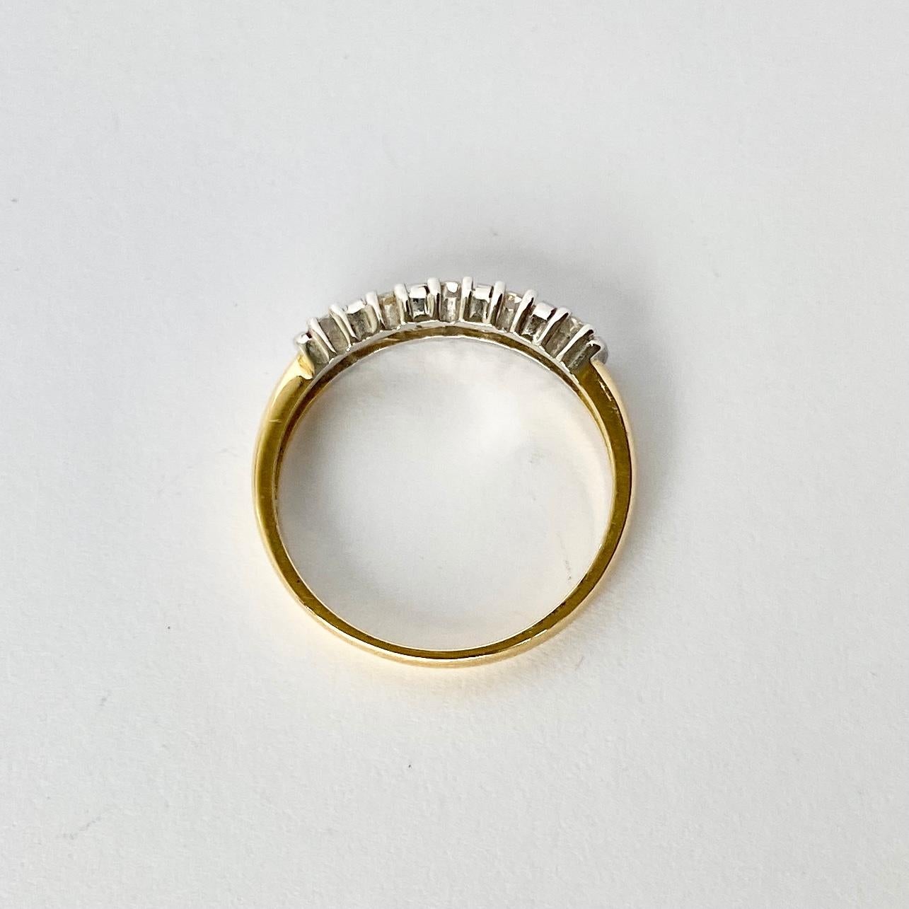 Five glistening diamonds sit fabulously on top of a simple setting modelled in 18ct gold and platinum. The diamond total is 75pts.

Ring Size: Q or 8 
Width: 3.5mm
Height Off Finger: 3mm

Weight: 3.2g