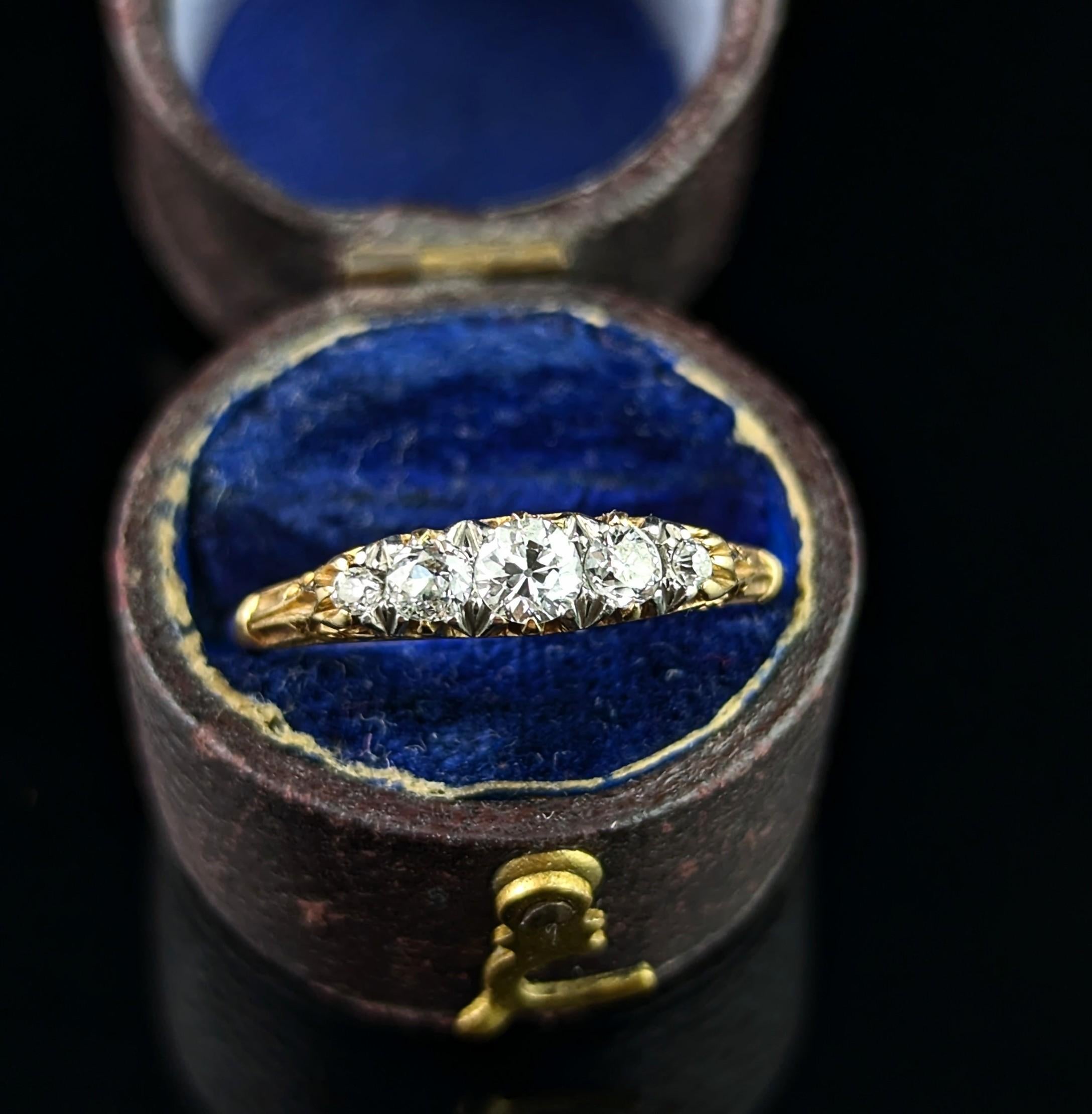 A stunning vintage, mid century era five stone diamond ring in 18ct yellow gold. 

This spectacular beauty features four graduated old cut diamonds, the largest being the centre stone is a brilliant cut. 

The diamonds have an approx 0.25ct total