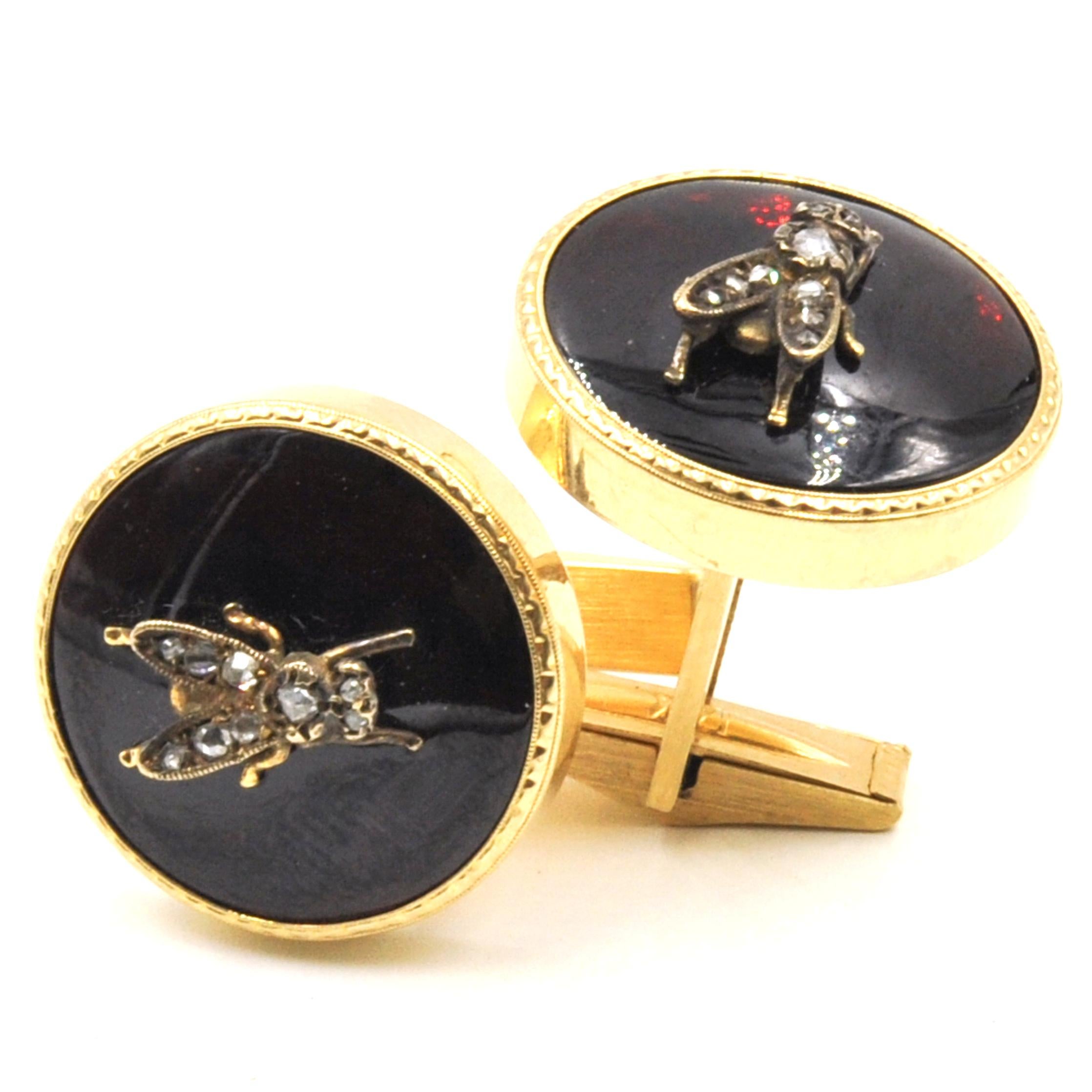 Beautiful pair of cuff links crafted in 14k Yellow Gold. The pair is is highlighted with Flies that are set with Rose Cut Diamonds along the center. Nine Diamonds set in each fly approximately .20 tcw in the pair. The flies are step atop a resin