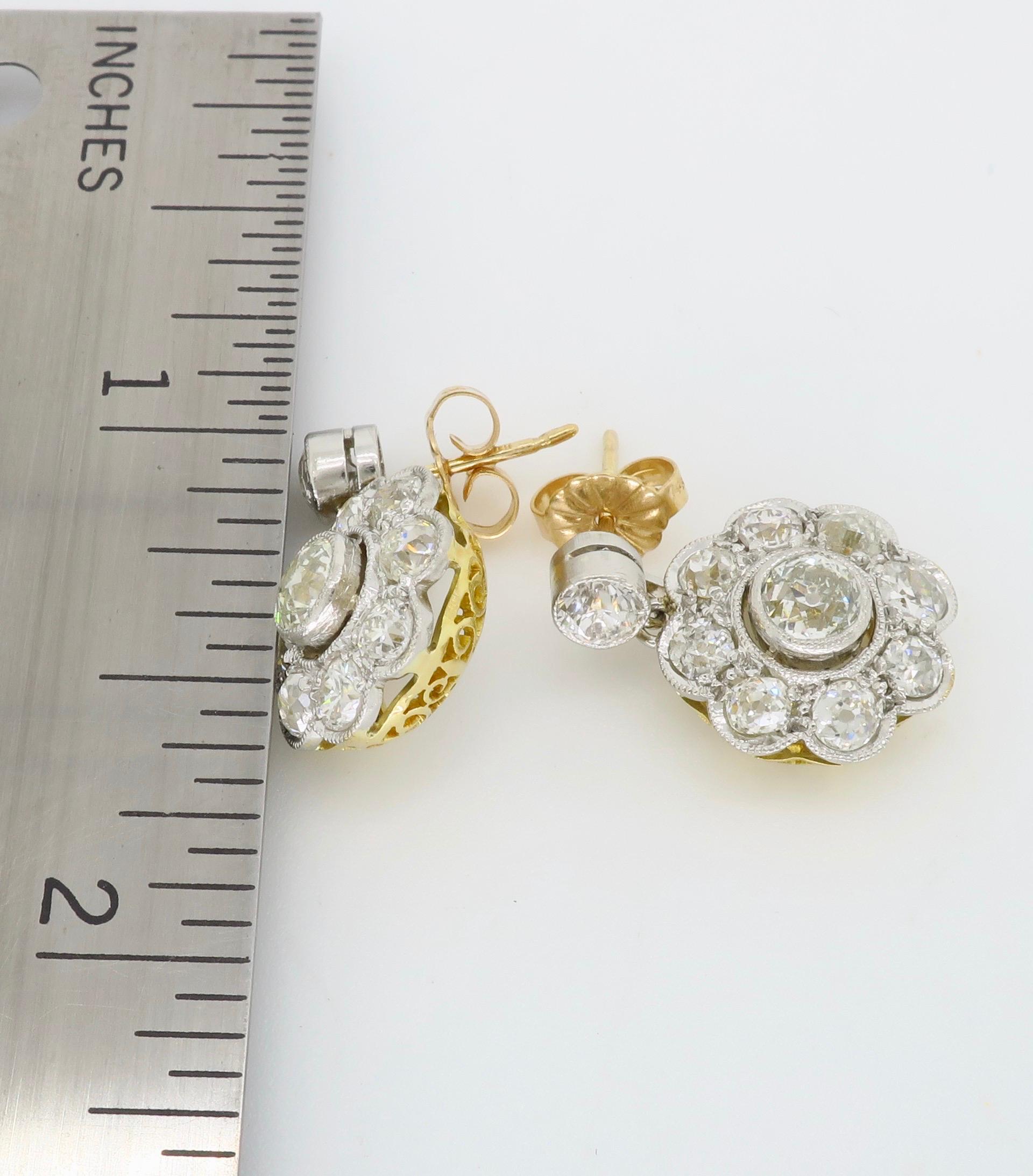 Vintage approximately 2.66ctw dangle diamond earrings crafted in platinum and two tone white and yellow gold.

Diamond Carat Weight: Approximately 2.66CTW 
Diamond Cut: Old European Cut
Color: Average H-L
Clarity: Average SI-I
Metal: Platinum