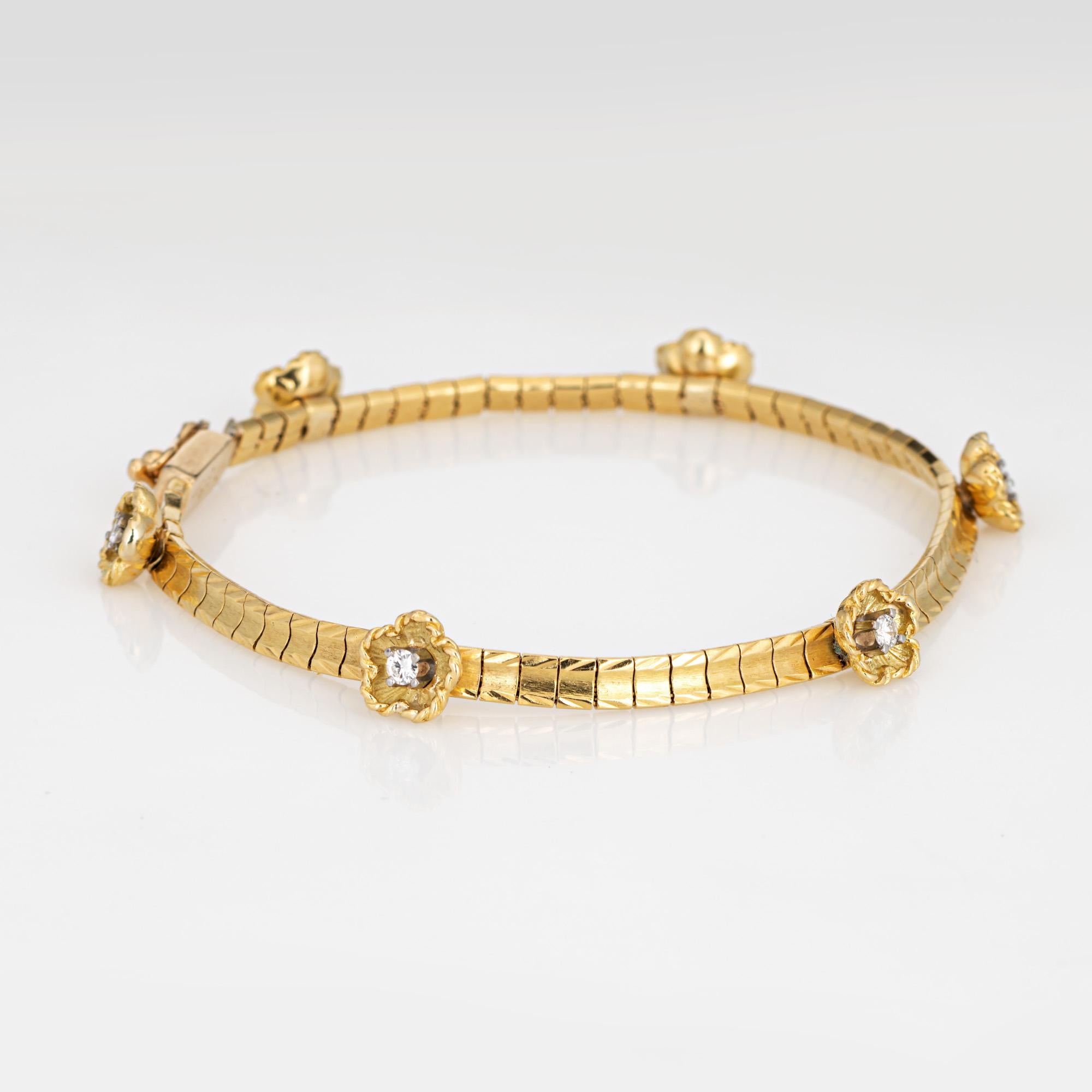 Finely detailed vintage diamond flower bracelet (circa 1950s to 1960s), crafted in 14k yellow gold. 

6 round brilliant cut diamonds total an estimated 0.15 carats (estimated at I-J color and VS2-SI2 clarity).
The stylish bracelet features 6 raised