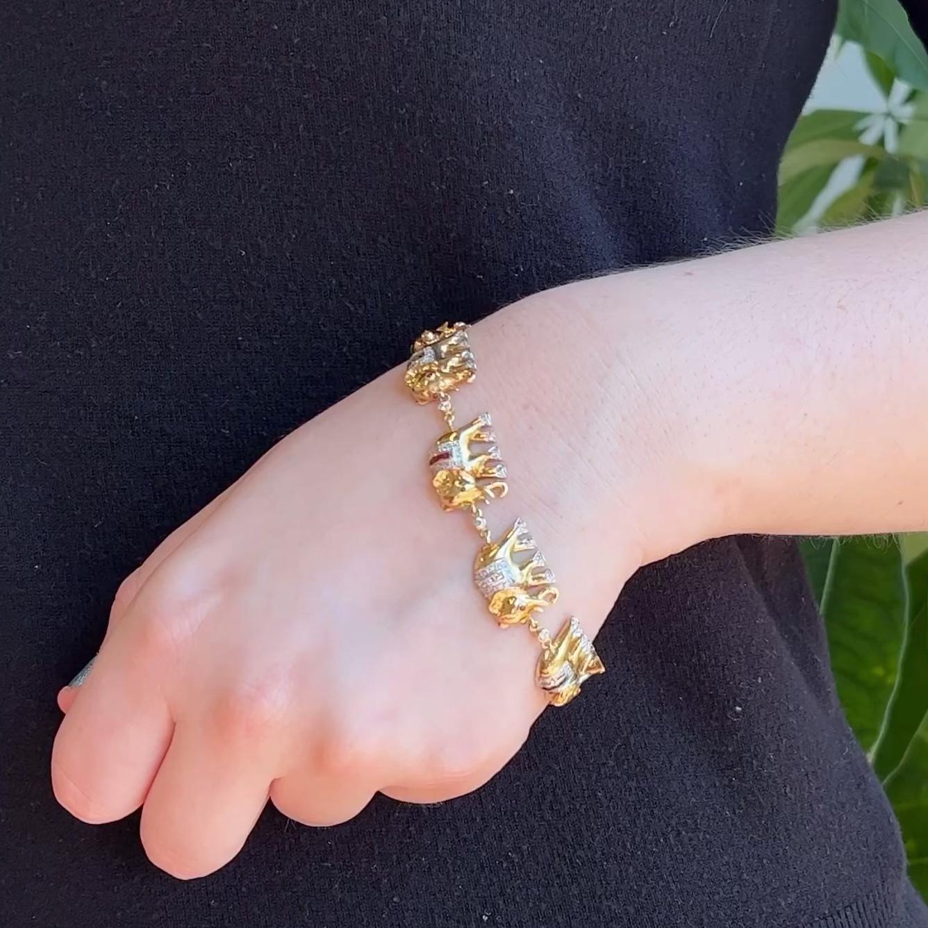 One Vintage Diamond Gemstone 18 Karat Yellow Gold Elephant Bracelet. Featuring 135 round brilliant cut diamonds with a total weight of approximately 1.25 carats, graded near-colorless, VS clarity. Accented by 16 mixed cut rubies with a total weight