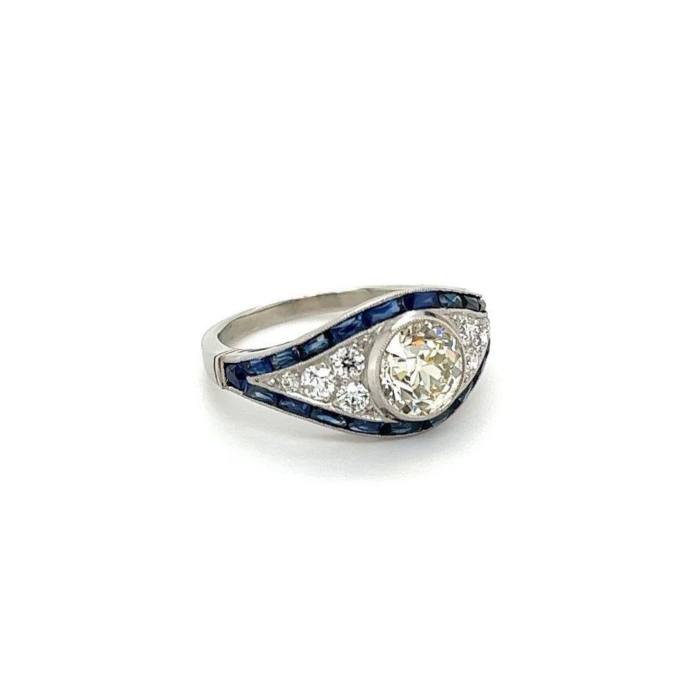 Simply Beautiful! Elegant and finely detailed GIA Diamond and Sapphire Art Deco Revival Platinum Cocktail Ring. Centering a securely nestled Hand set 1.52 Carat Old European Cut Diamond; N-SI1 GIA. Surrounded by 0.40tcw OEC Diamonds and 2.20tcw