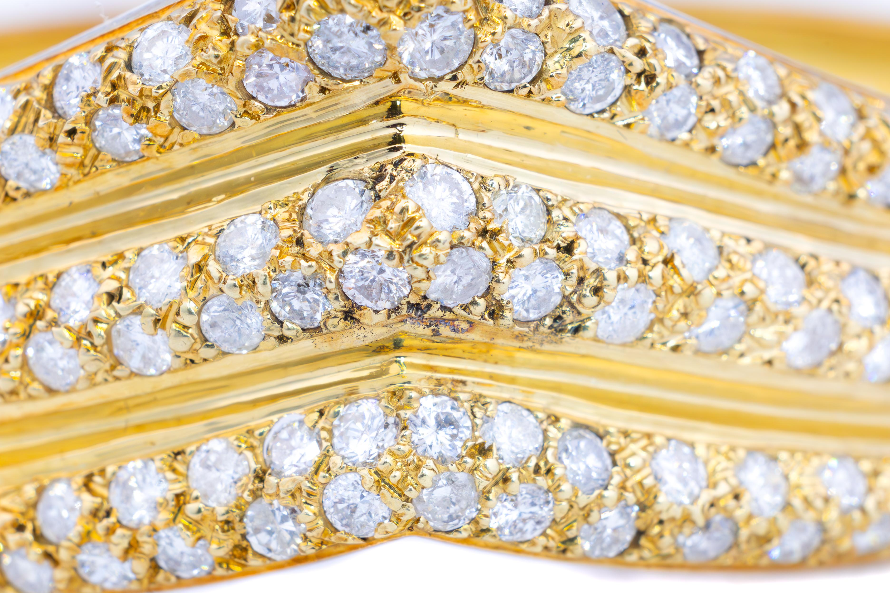 Vintage Diamond Gold Bangle Bracelet

This striking vintage bangle bracelet is a testament to refined artistry and elegance, crafted in 14-karat yellow gold and adorned with a dazzling array of round-cut diamonds. The bold chevron motif is