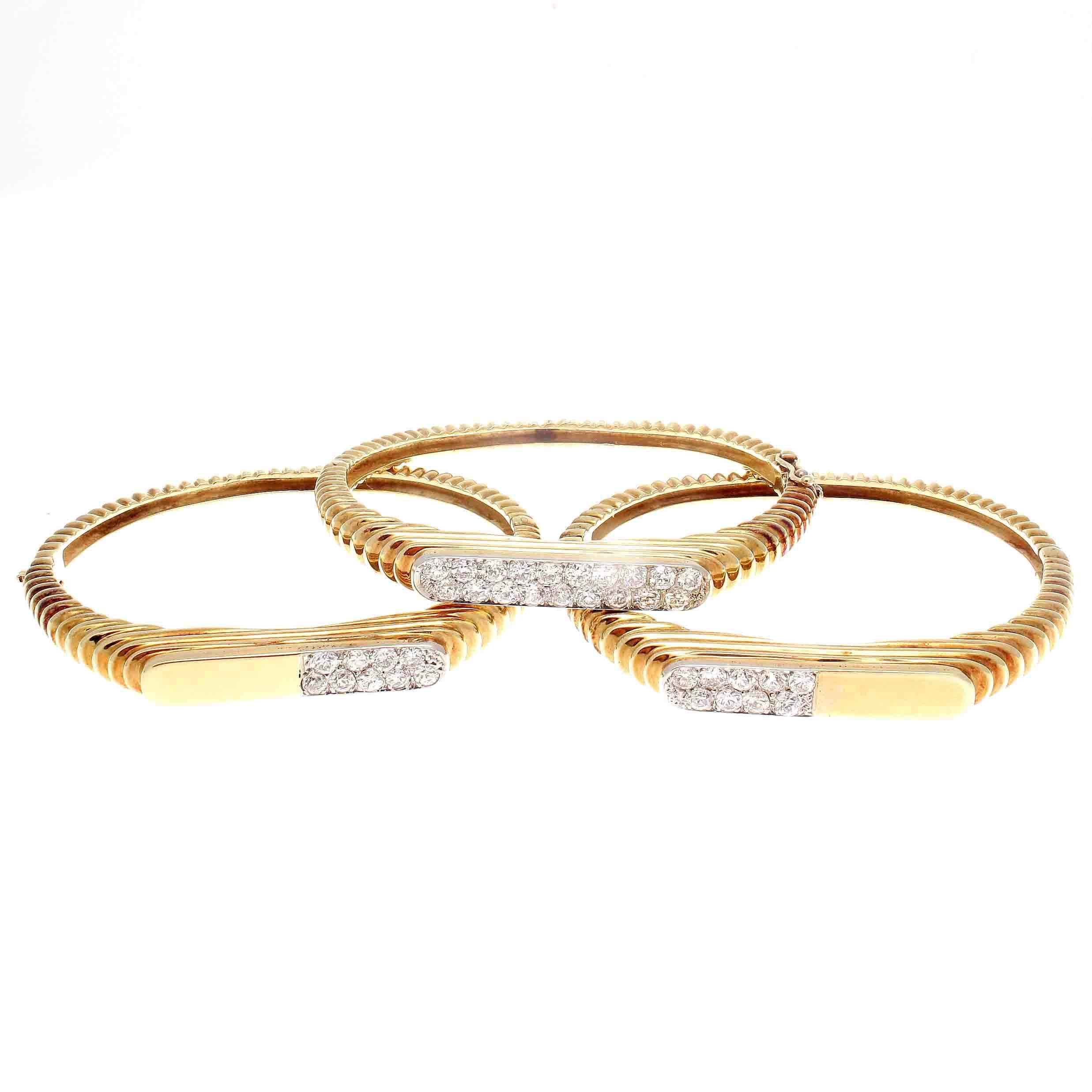 Mix and match however you like with these stylish bangles. Featuring 37 colorless diamonds weighing approximately 2 carats. Hand crafted in 18k yellow gold.
