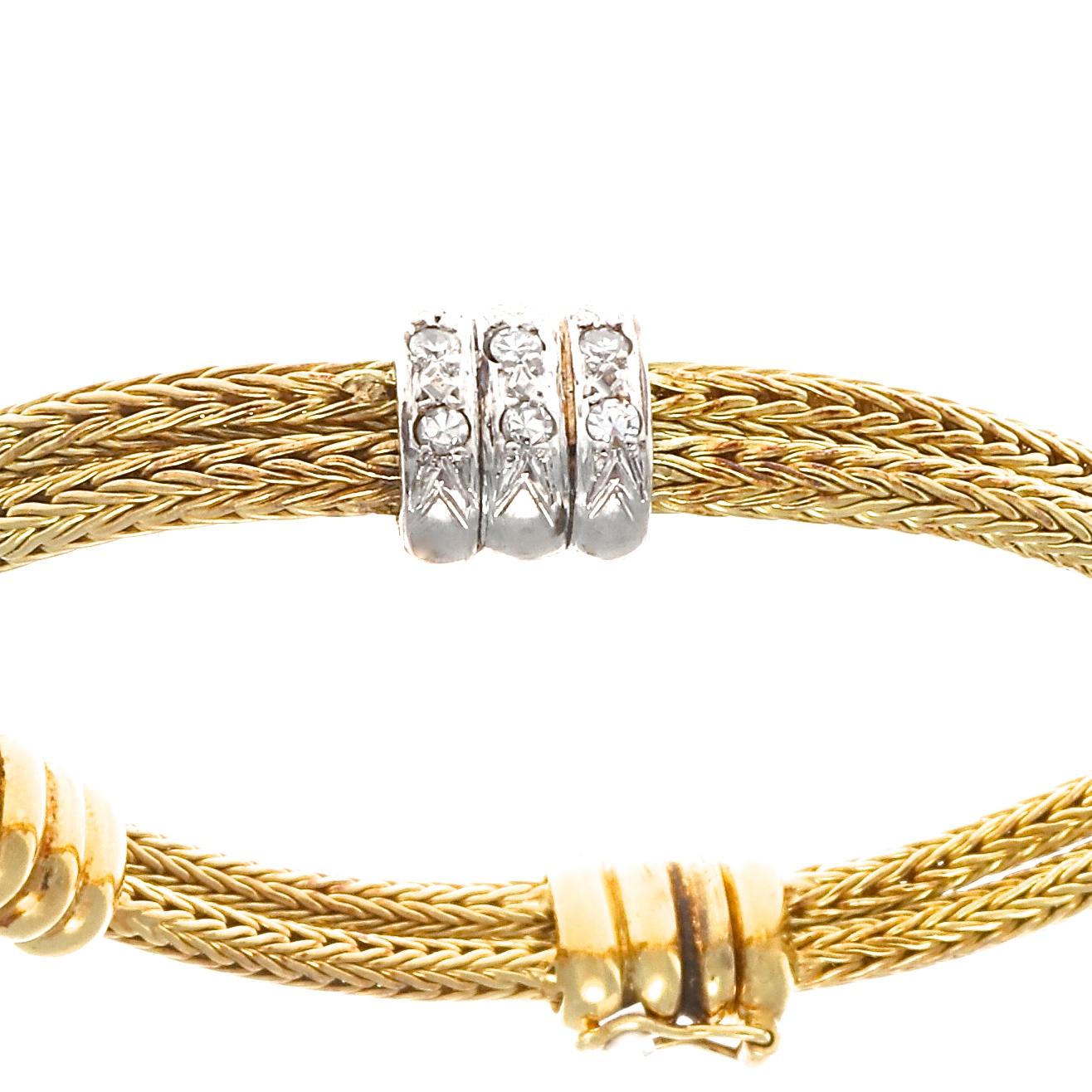 A bangle worthy of welcoming the company of other bracelets or sufficient and classic  on its own. Designed in the classic rope motif bounded together by knots of diamonds. Crafted in 18k gold.