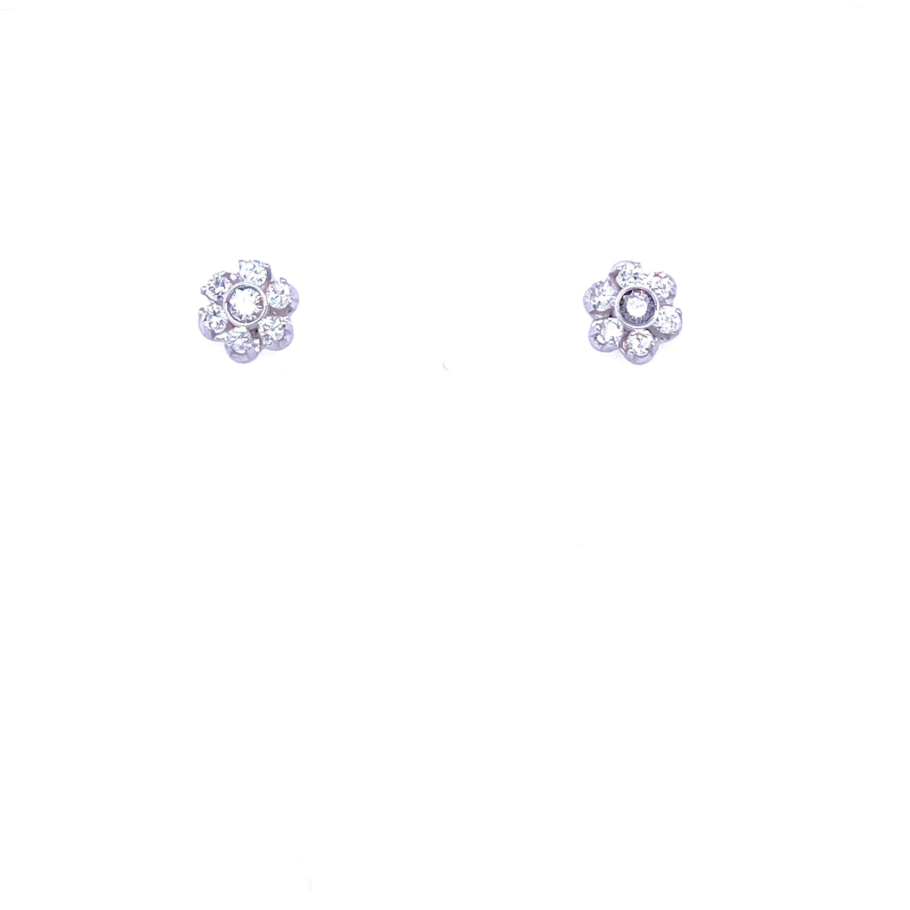 Pretty pair of vintage diamond cluster earrings set in solid 18k Gold. They are set with Round Brilliant cut Diamonds graded color G clarity Vvs2. 
Origin Italy 1980

CONDITION: Pre-owned - Excellent 
METAL: 18k Gold
STONE: Diamond 0,60 total